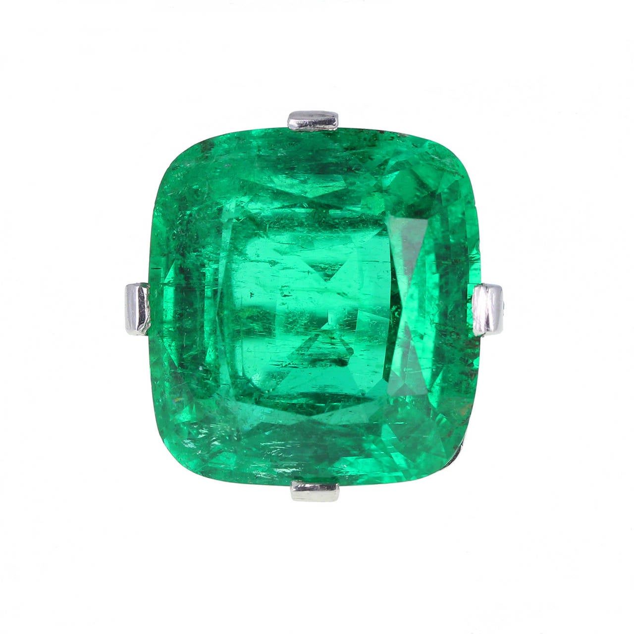 Bold and magnificent, this rampant Art Deco cocktail ring by Cartier Paris features a massive 30.00 carat cushion-cut emerald of exceptional colour that we have found difficult to capture in our images. Independently certificated by SSEF, the world