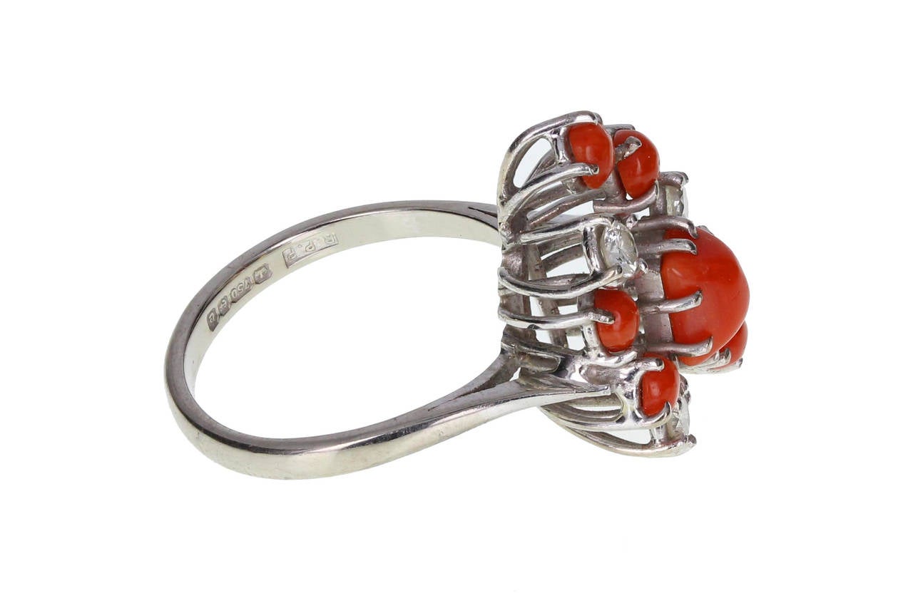 This unusual ring features square and round cabochons of impressive red coral, accented by round, brilliant-cut diamonds, all mounted in 18ct white gold. A stylish, bold ring with fine quality gems. Hallmarked Birmingham. Total diamond carat weight