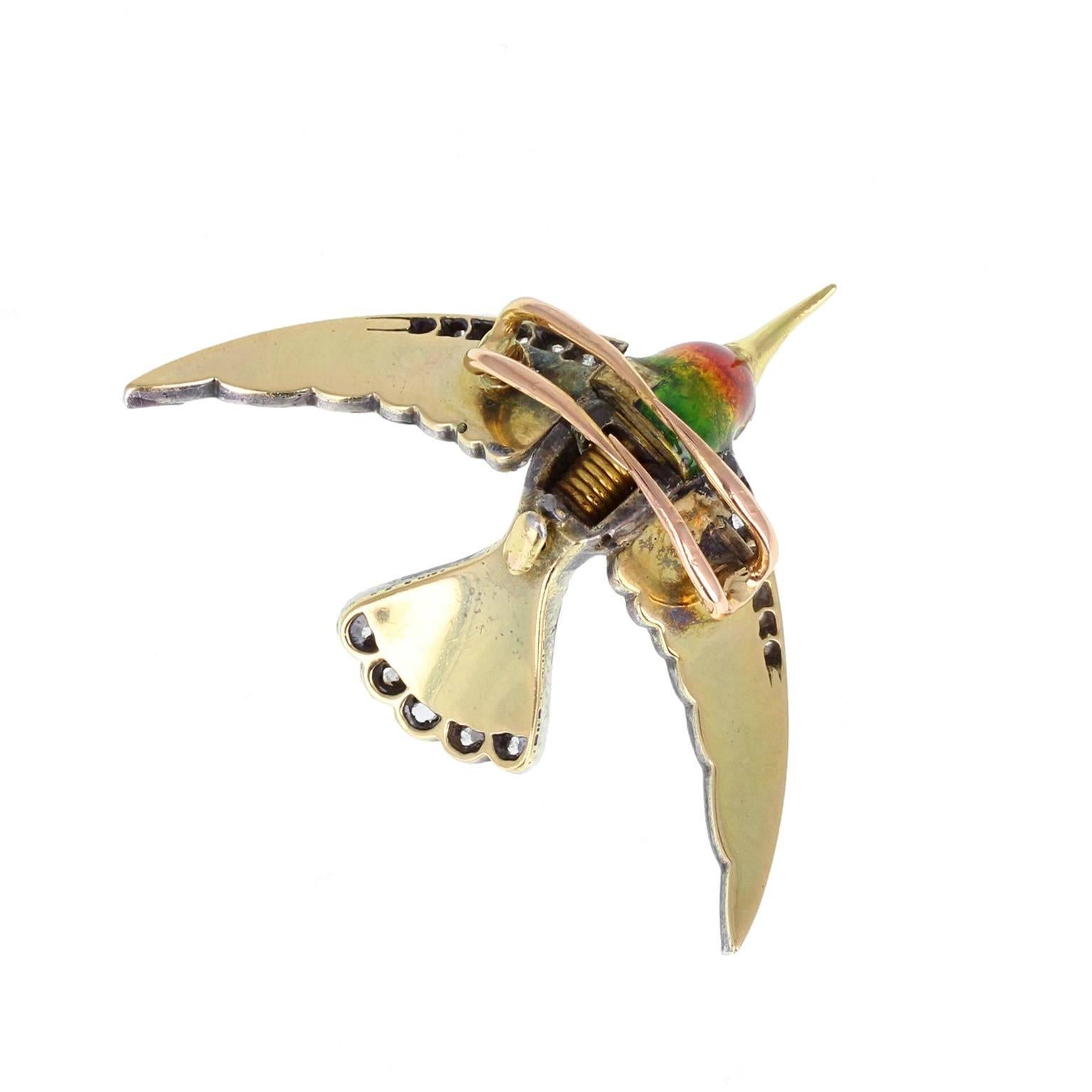  This delightful antique brooch is masterfully crafted in 18 carat gold. The body, wings and head enamelled with purple, turquoise, gold, green and red enamel and adorned with rose-cut diamonds. Hinged, sprung wings operate the ingenious clasp. A