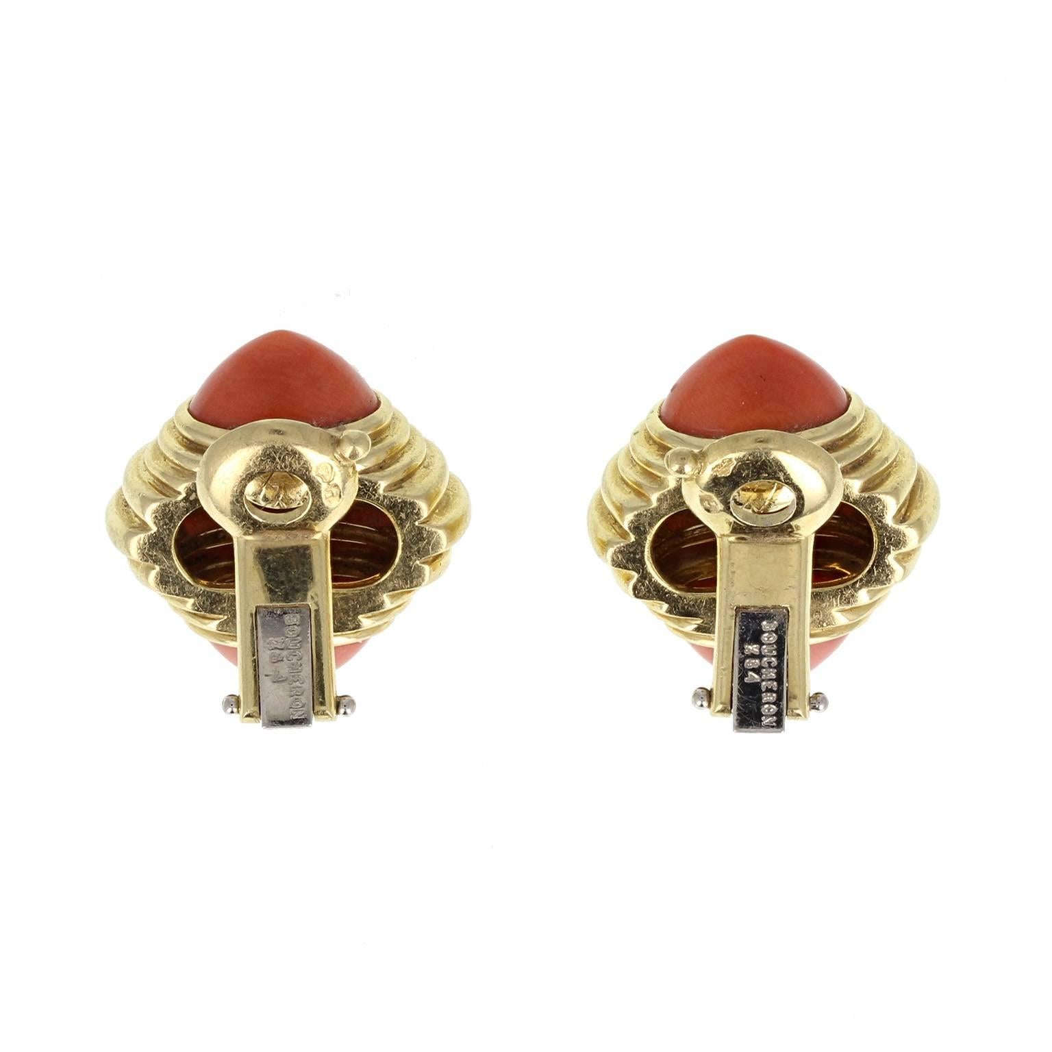 Instantly recognisable as Boucheron in style, these retro styled ear clips can be worn by those with or without pierced ears. The ridged central gold section tapering to a pink coral pyramid shaped cabochon to the top and bottom of each earring.