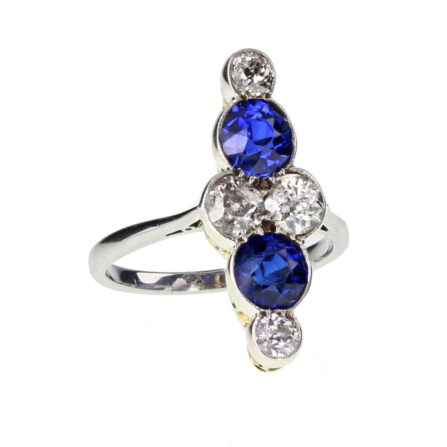 A typically styled 1920s sapphire and diamond ring featuring two old-cut sapphires and four old-cut diamonds set to form a lozenge shaped cluster. Platinum and gold setting with a platinum shank. Excellent condition and exceptionally value Art Deco