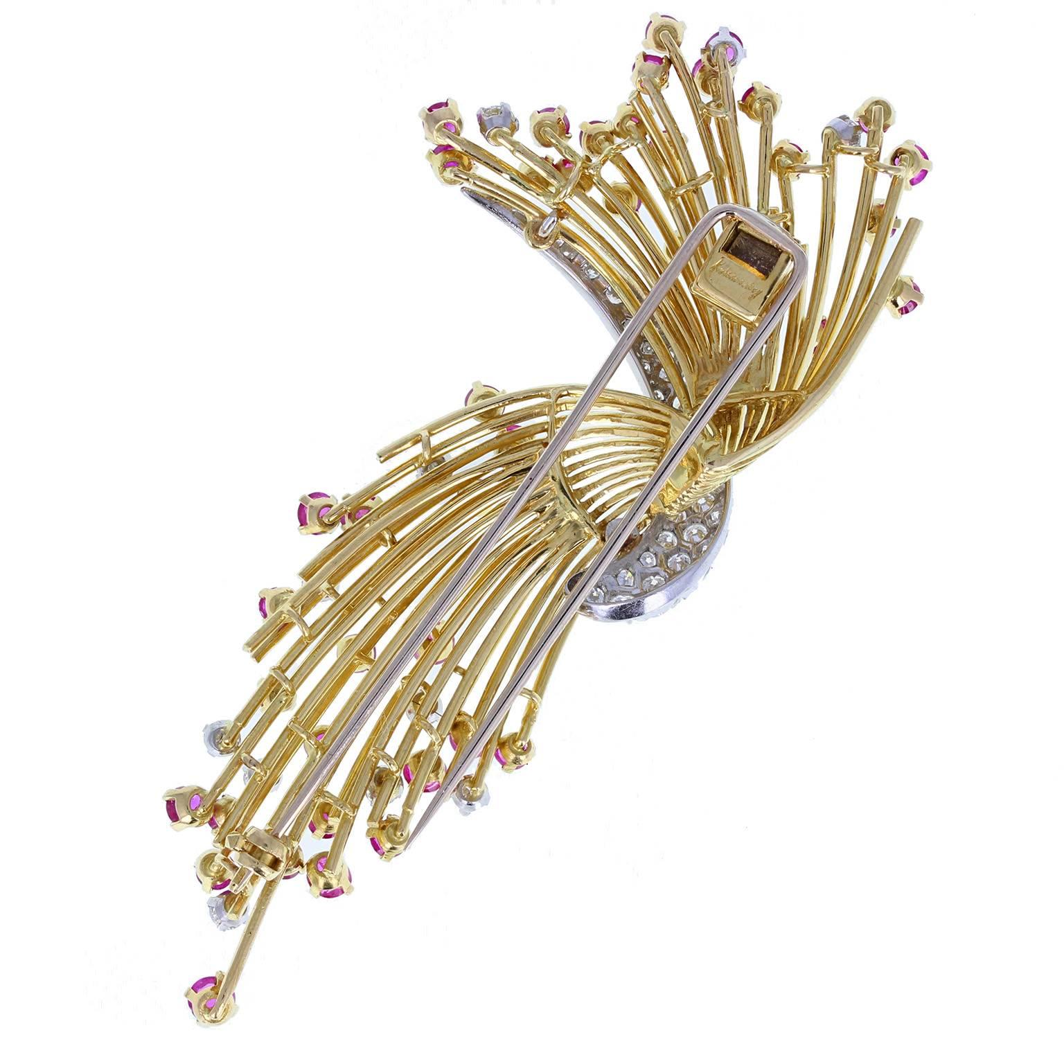 Unmistakably Kutchinsky in style, this vintage brooch features a spray of gold wires, set with blood red rubies and diamonds, emanating from a central pave-set diamond section. Signed Kutchinsky.
 
Setting
Tests as 18 carat gold
 
Ruby
Weight: