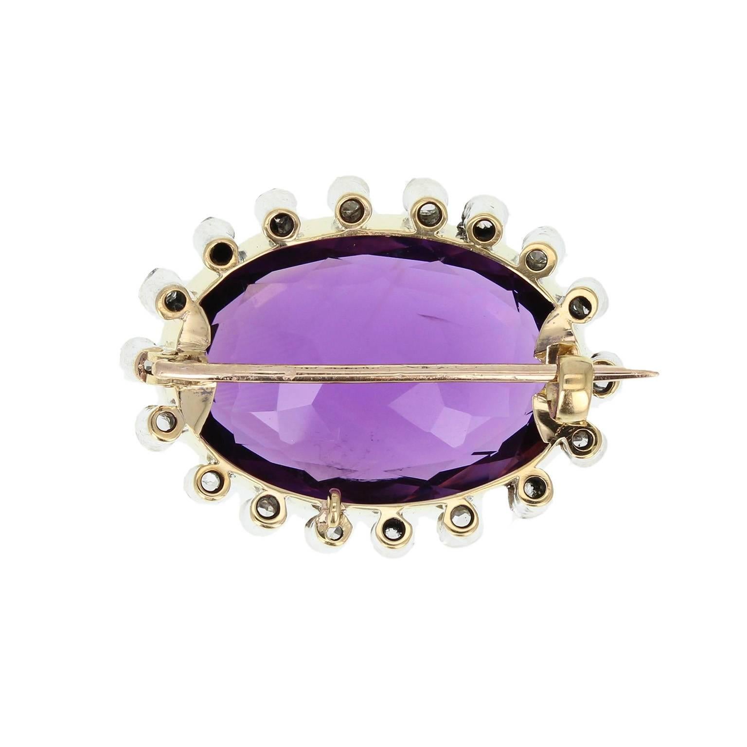 An exquisite colour amethyst with excellent saturation, rub-over set in a mille-grain edge. Surrounded by 18 individually rub-over set old-cut diamonds. An excellent example of Victorian 15ct gold and silver jewellery set with a particularly