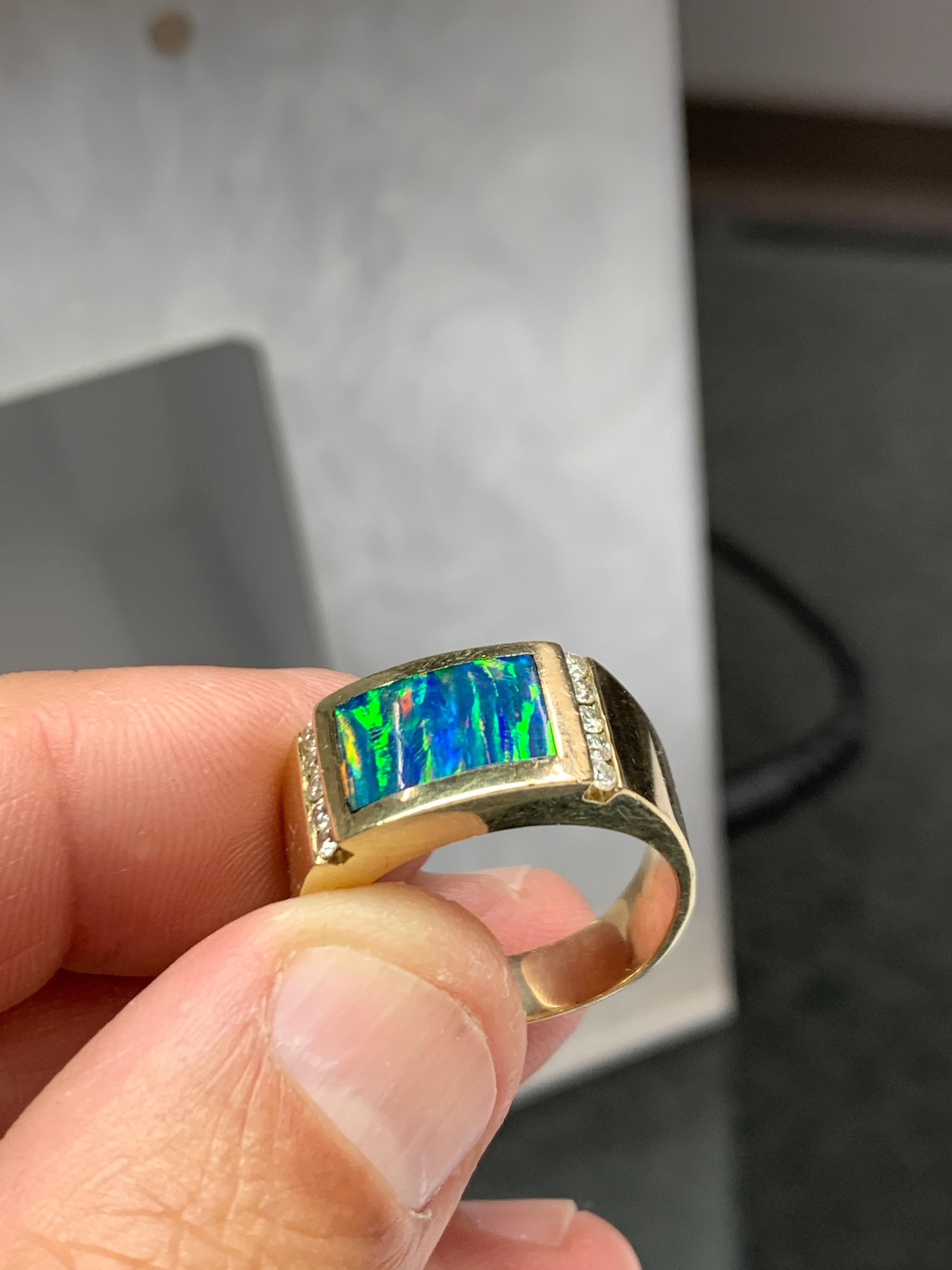 Retro Men’s 14k Yellow Gold Ring , Size 12.

Natural Opal Doublet Gem Stone (12x8mm) & ten 0.30 Carat (H SI) Natural Diamonds, Circa 1970. 

Weight of the ring is 11.57 grams.

Shipped with USPS First Class Package.