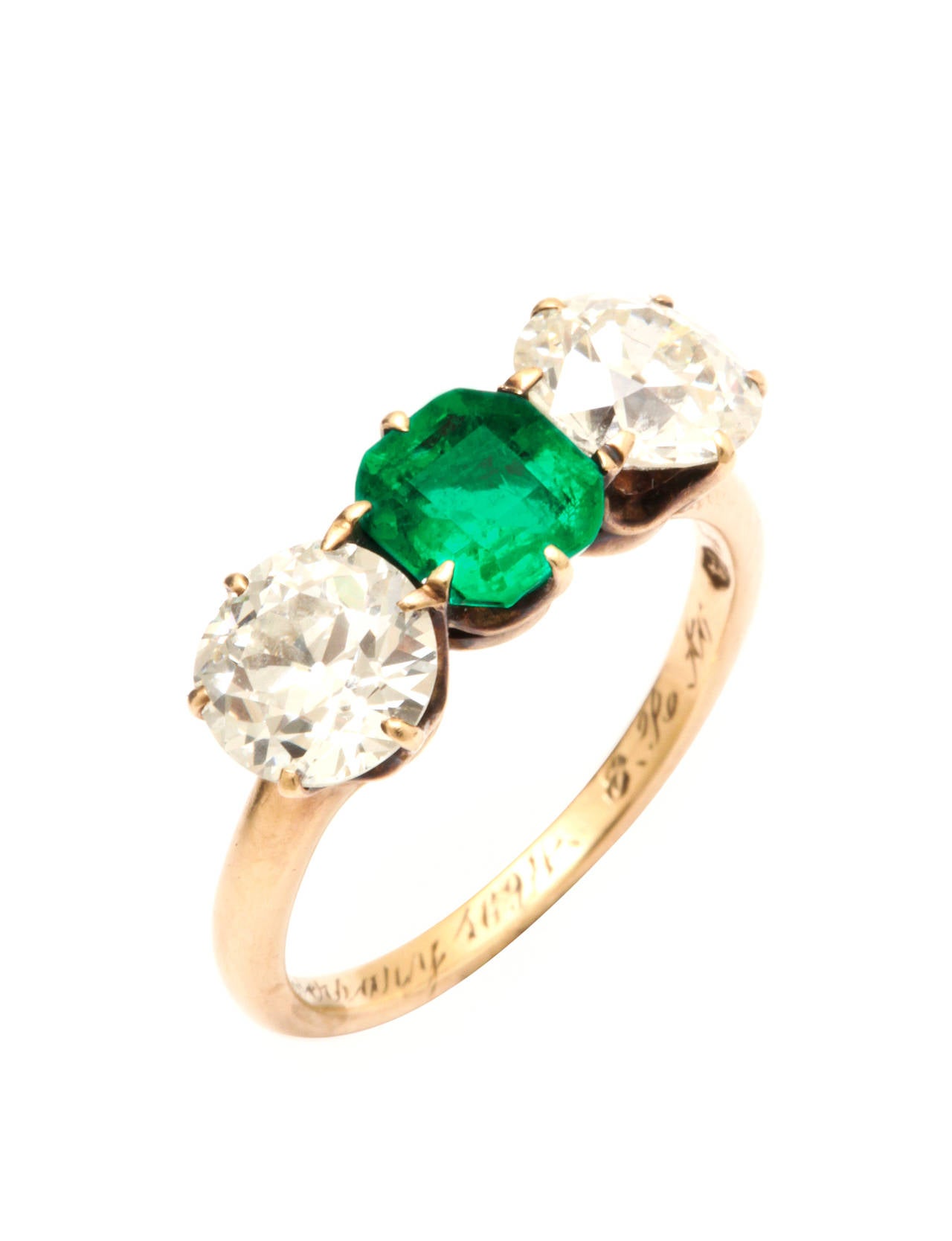 This Edwardian Emerald and Diamond ring is set in 14K yellow gold. 

Estimated diamond weight: 2.49ct total, I - J color, VVS clarity

Estimated emerald weight: 0.95ct, Columbian origin

Size 7.5

Engraving on inner band reads, 