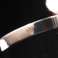 Pulsera tipo brazalete con bisagra de Brighton Venezia, en tono plateado, con motivos en espiral grabados y firmada