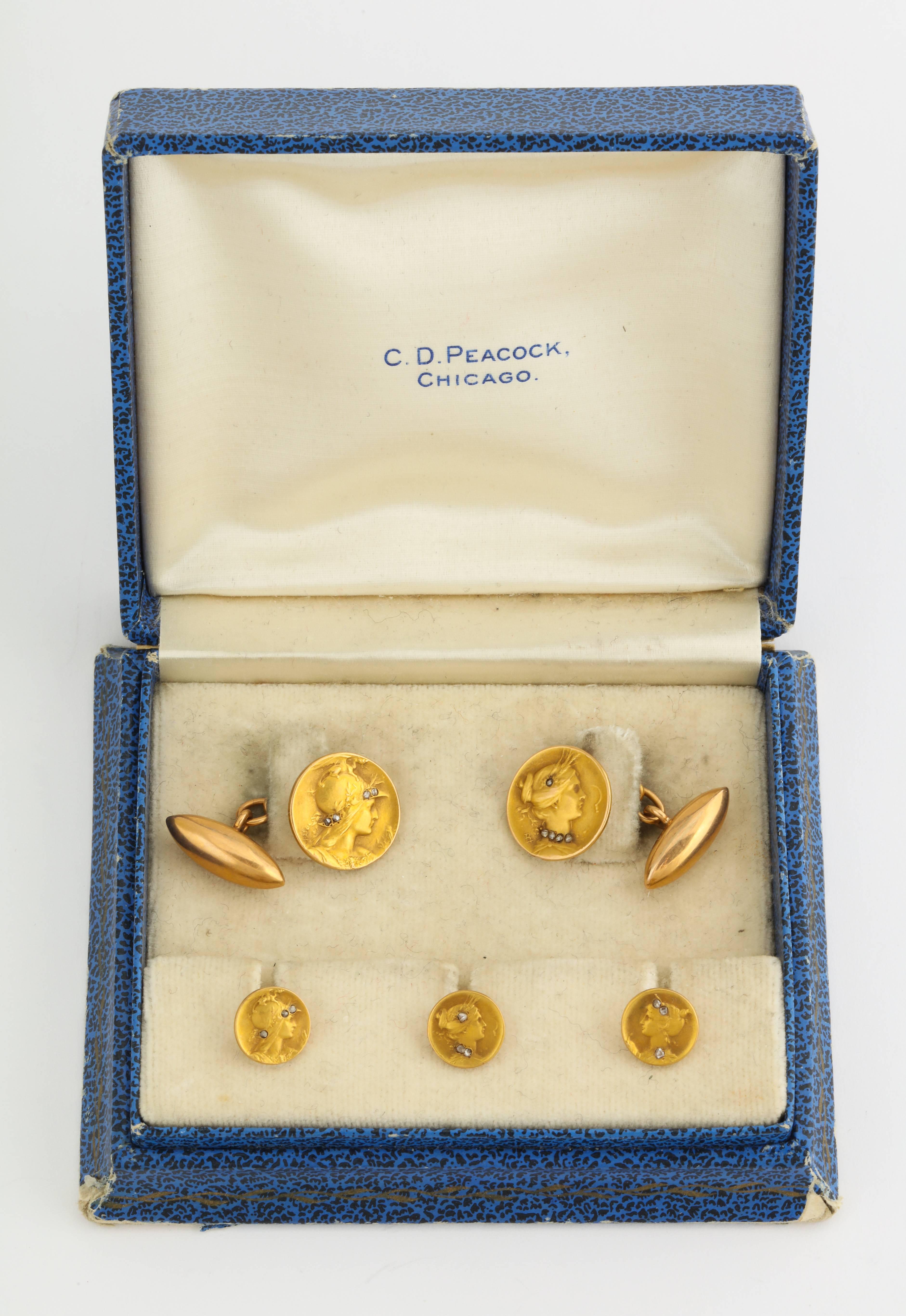 A beautiful and early stud set by the renown French Art Nouveau engraver of gold medal jewels and designer for Boucheron c1880, Comte Prosper d'Epinay De Briort. The set includes cuff links and three stud buttons of 18K gold displaying sculpted