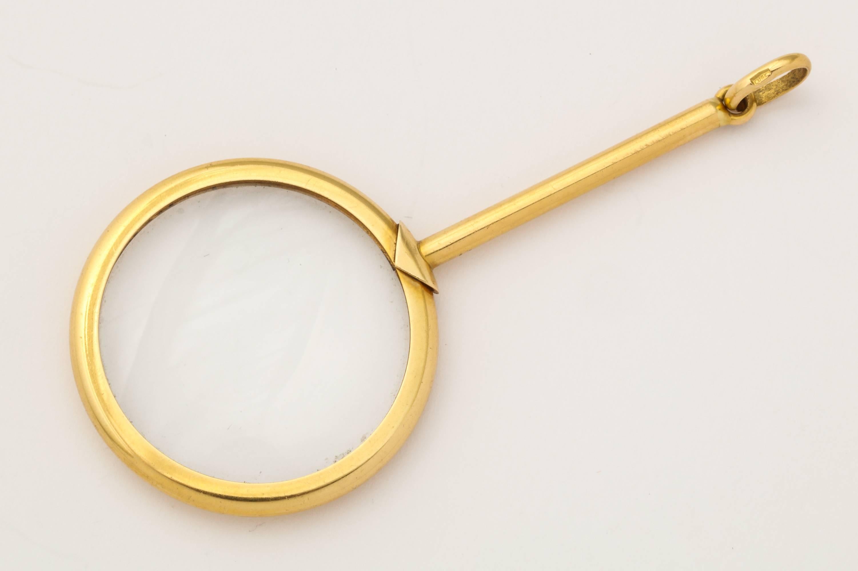A simply elegant miniature magnifying glass in 18K gold, from a 1910s man's watch fob, but now also for a lady's chain. Italian gold marks. 2 5/8 inches long.