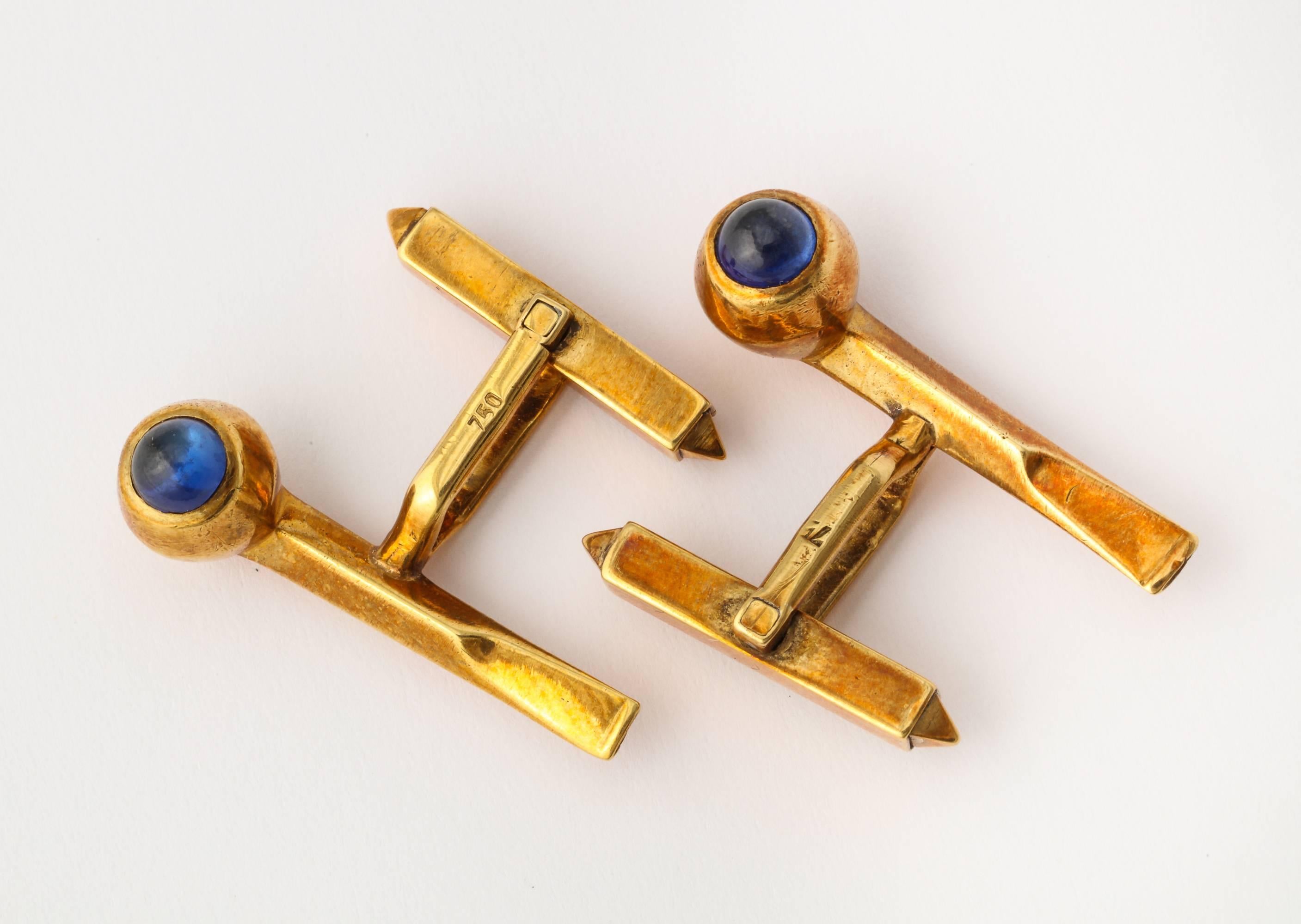 A whimsical pair of cuff links in 18K rose gold as well crafted figural pipes with cabochon sapphires in the bowls. 750 Gold mark. 1 1/8 inches long.
