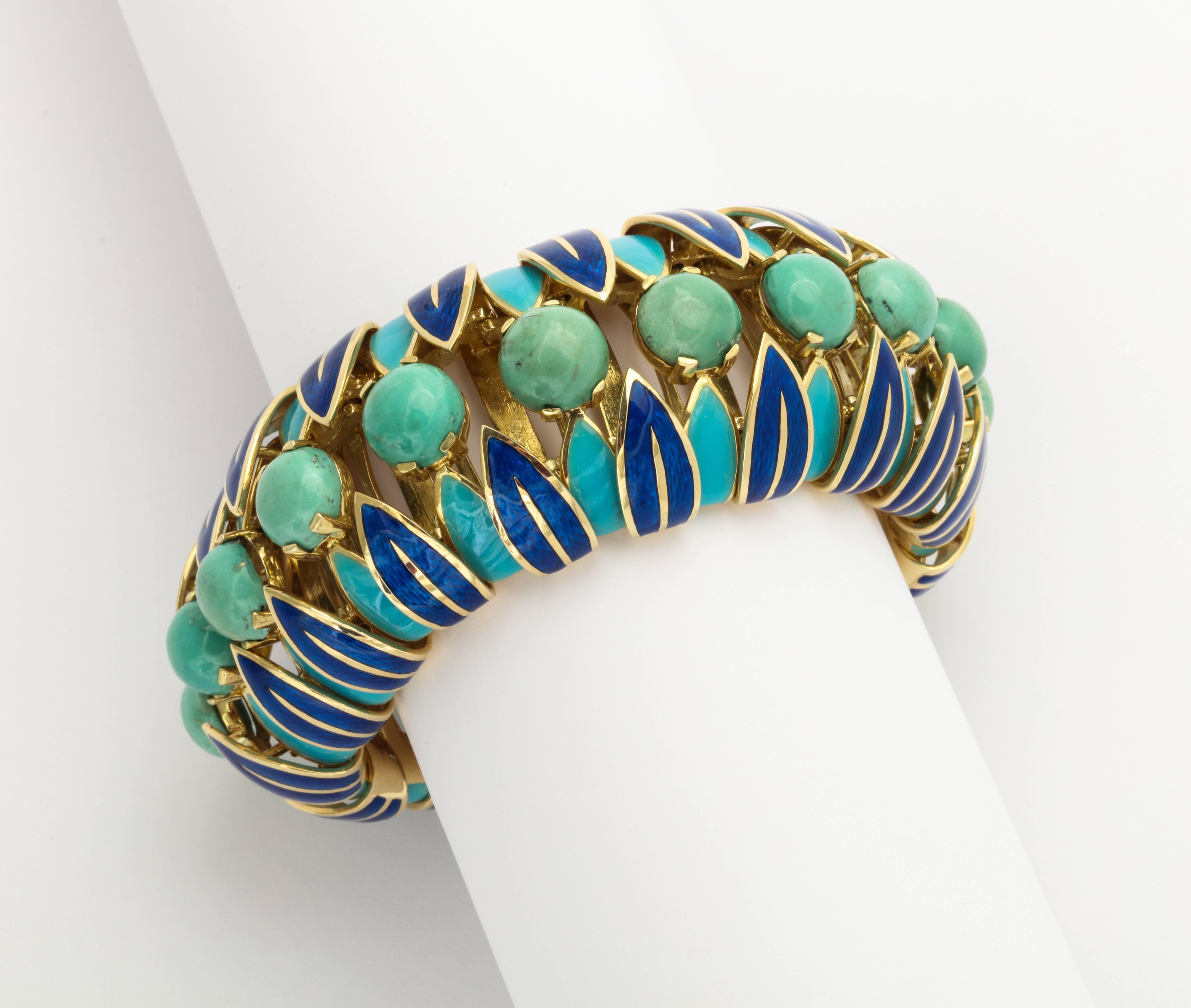 A stunning Egyptian inspired 1960s bracelet by *Jeffrey Barbara of Palm Beach Florida, custom made of 14K gold set with cabochon turquoise complimented by two colors of enamel leaves. 1 5/8 x 8 inches. Nicely articulated. Unmarked.
*Designer