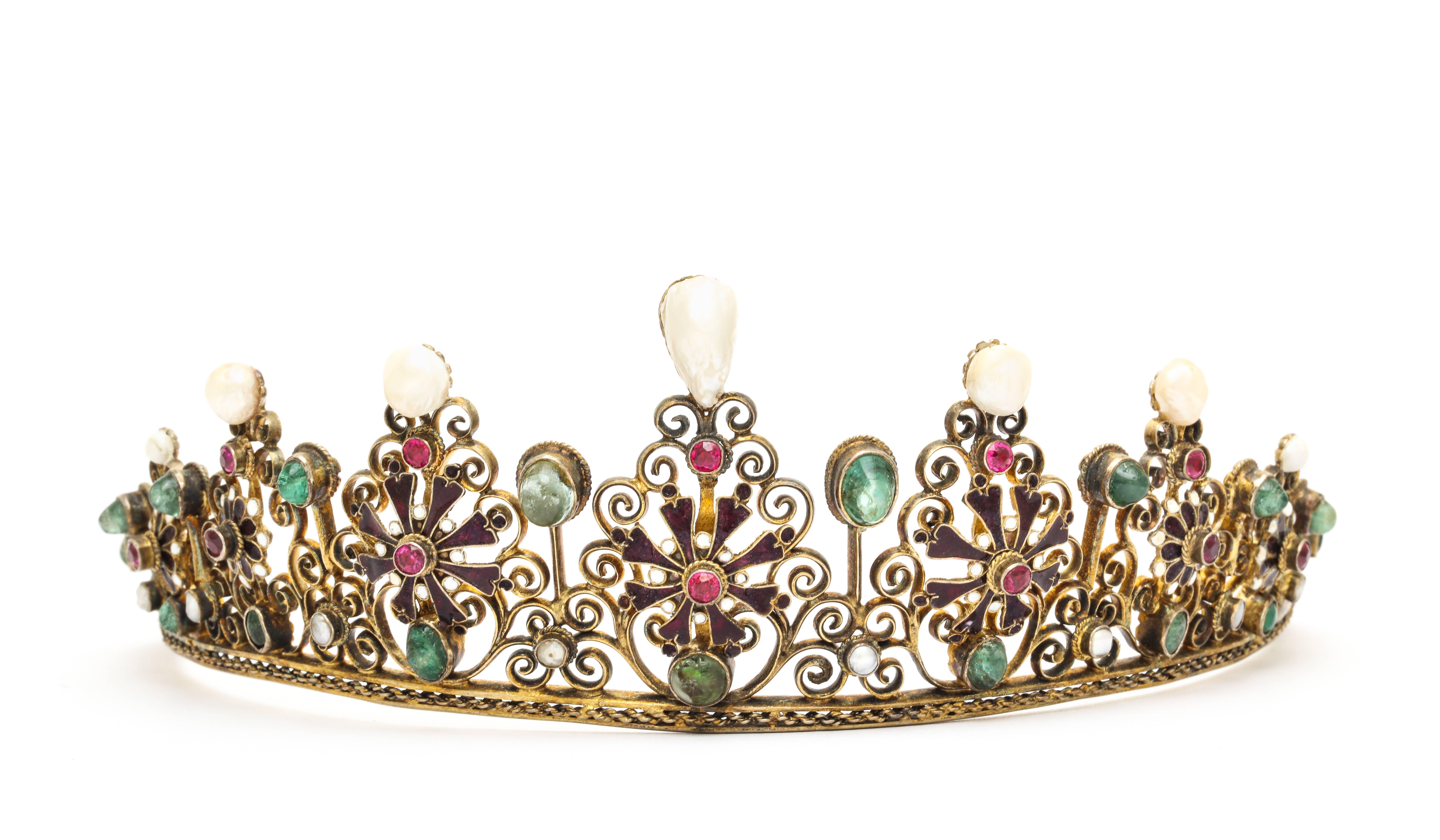 Circa 1860 Austro-Hungarian gemstone tiara of gold gilt silver filigree with enamel details set with emeralds and rubies and highlighted with natural pearls.   in original leather travel case. Marked WM, 56.3 grams, 2 inches x 9 1/2 inches, one