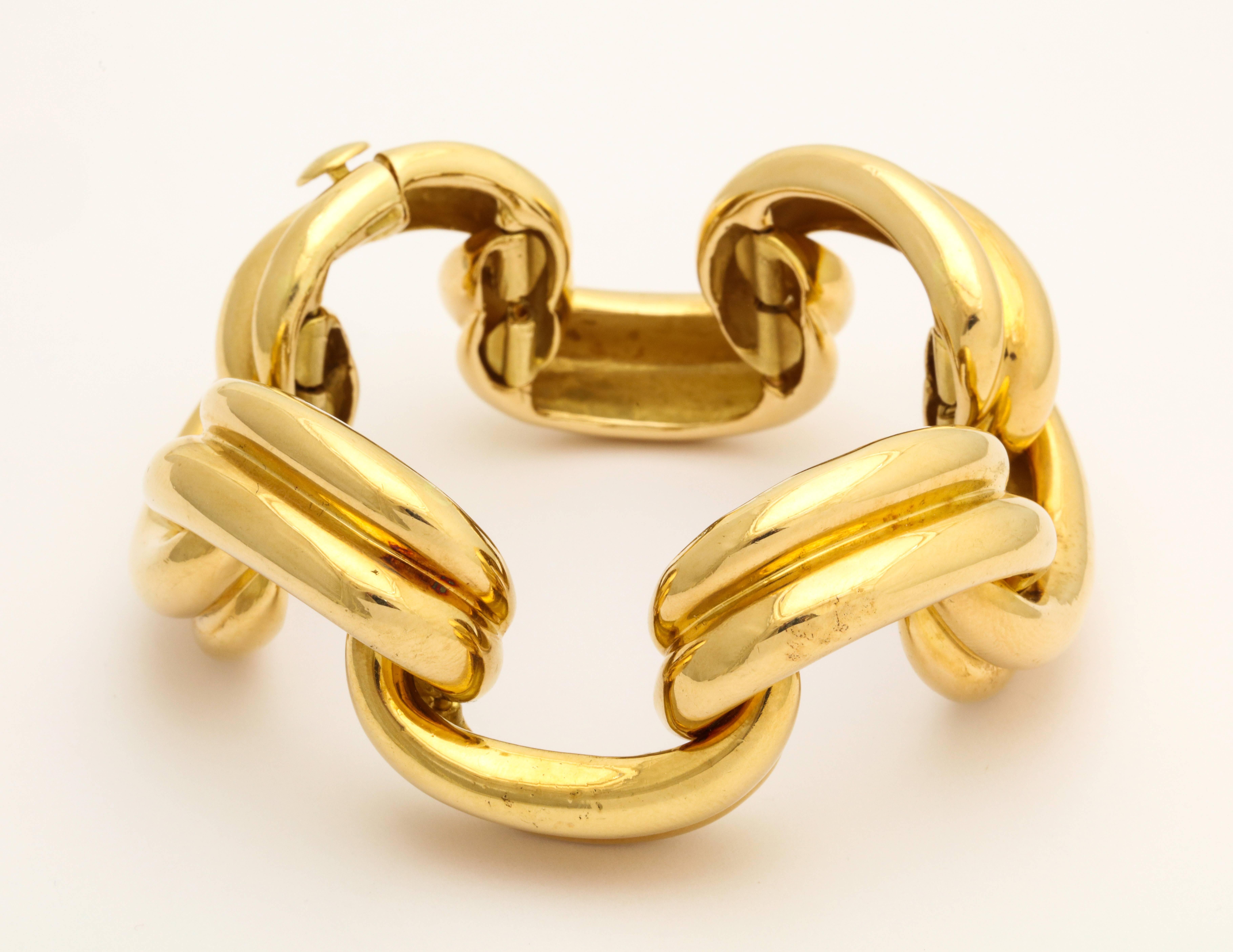 Perfectly elegant, this vintage Craiger Drake 18K gold bracelet wraps the wrist in a 3-dimensional series of alternating draped ribbon swags, each enhanced with a touch of pale brown enamel in the recess enhancing the total effect. Drakes designs