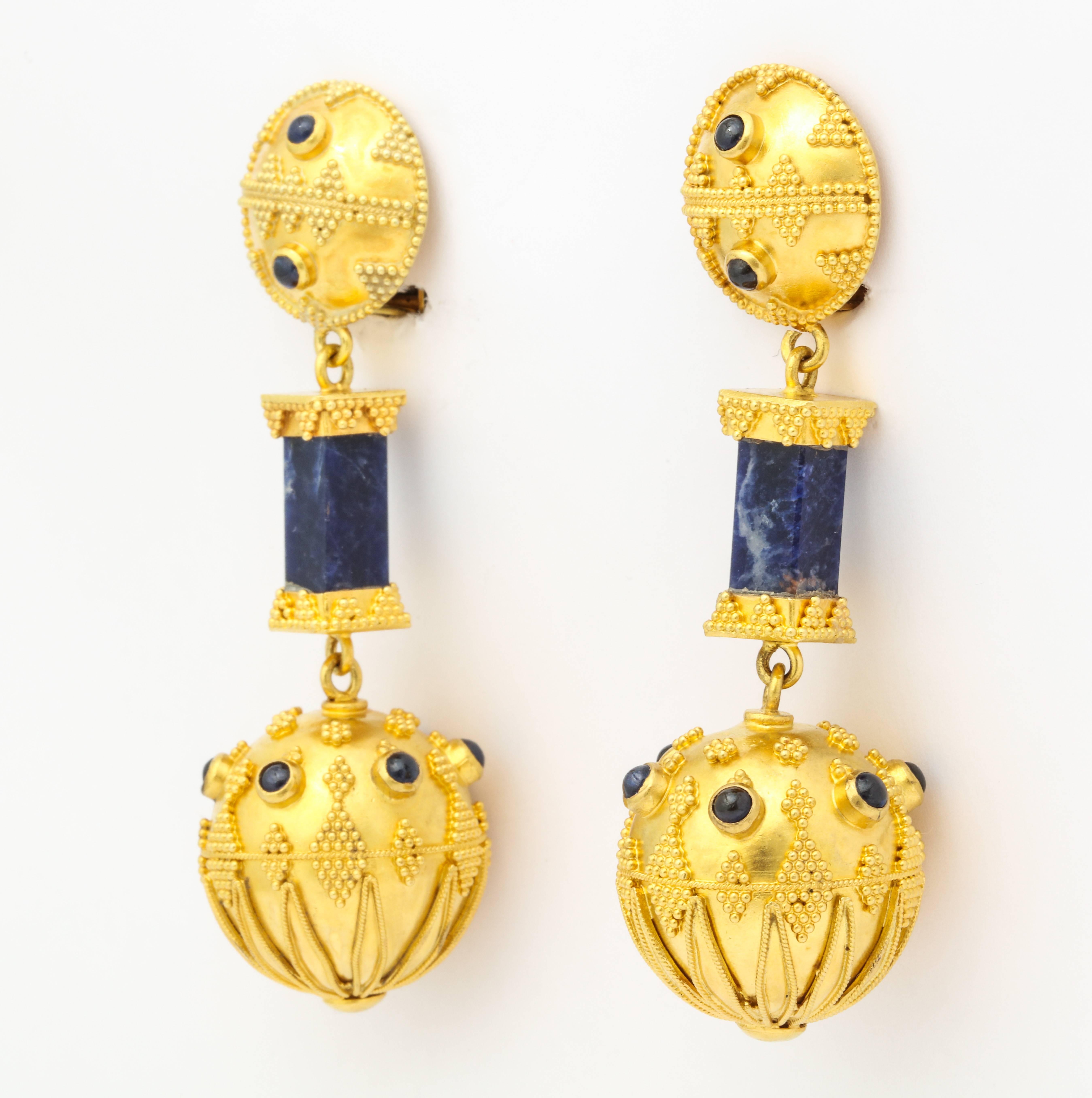 Stunning 1970s earrings recreating the 4th Century Hellenistic Greek style made of 22K gold hung with square bars of rich deep lapis, and gold balls studded with Lapis cabochons, and an overall application of individual grains of gold - a dying