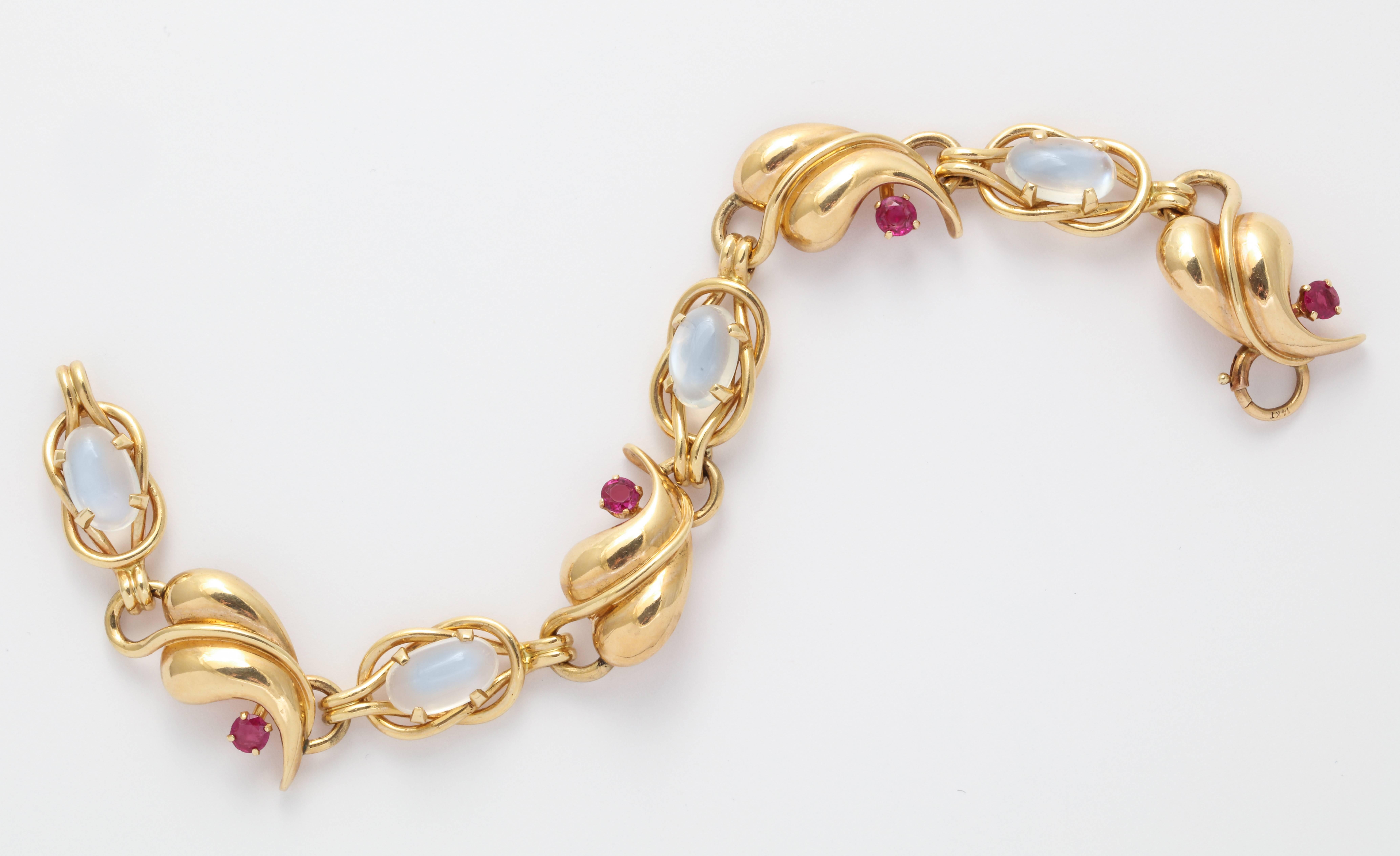 A very pretty 1940s 14K gold link bracelet set with glowing cabochon moonstones and natural rubies. 17.4 grams. 1/2 inch wide x 7 1/4 inches long.