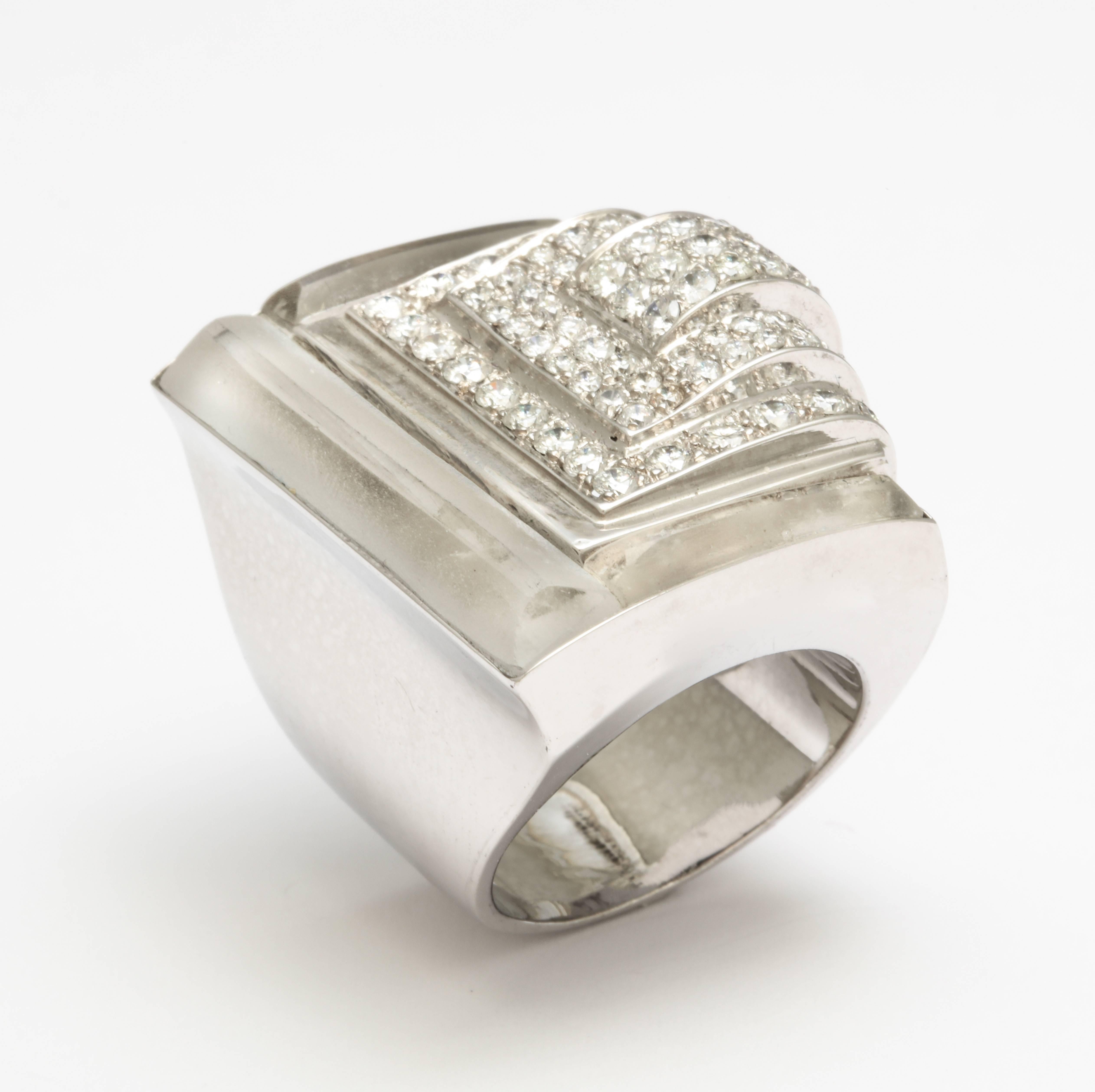 Highly impressive and fashionable, this architectural 18K white gold ring features three carved and frosted rock crystal panels framing a wave of stepped rows of diamonds (5.20 carats; GH-SI) ending in a cascade over one side. Stretching knuckle to