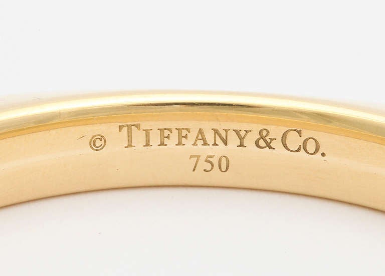 1990s Tiffany 18K yellow gold square bangle bracelet. Gold and Tiffany marks.  3 inch square. Fits 7 1/4 inch wrist. 50.07 grams.