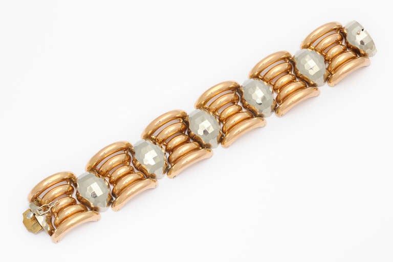 A spectacular and unusual 1940s Italian Retro bracelet crafted in tubular links of 18K rose gold, flanking grey gold links formed to imitate large faceted stones. 51.8 grams. 1 1/4 inches x 7 3/4 inches. Marked: 750, and unidentified makers marks.