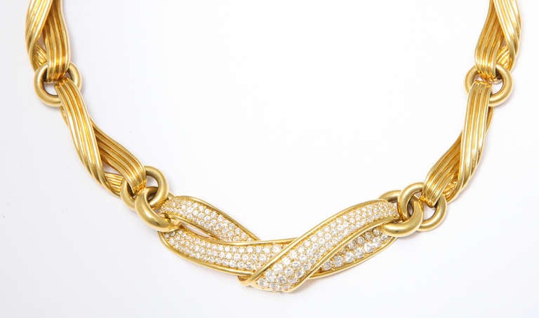 A beautifully crafted 1990s ribbon necklace by Jose Hess of heavy 18K gold, the central segment set with 7.45 carats of flawless finely matched white diamonds. Enjoy wearing it casually or for evening. Linked to conform to every neck. 
Includes a