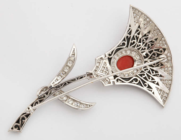 An elegant Italian 1970s 18K white gold brooch shaped as the classic Egyptian Lotus flower, set with red coral, black jade, and diamonds. 3 inches long. 18.351 grams. Marked: 750.