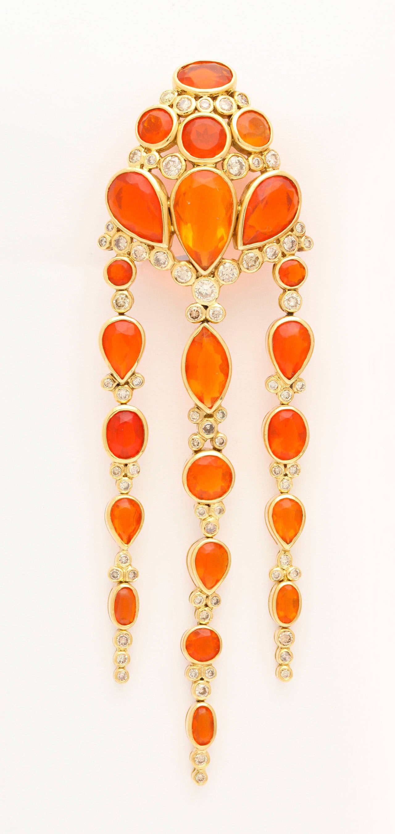 These stunning Marilyn Cooperman earrings glitter and glow with a cascade of Mexican fire opals and diamonds set in 18K gold. 1 inch wide and a generous 3 3/4 inches long. Signed, numbered, dated, and gold marked.
Marilyn is an exclusive New York