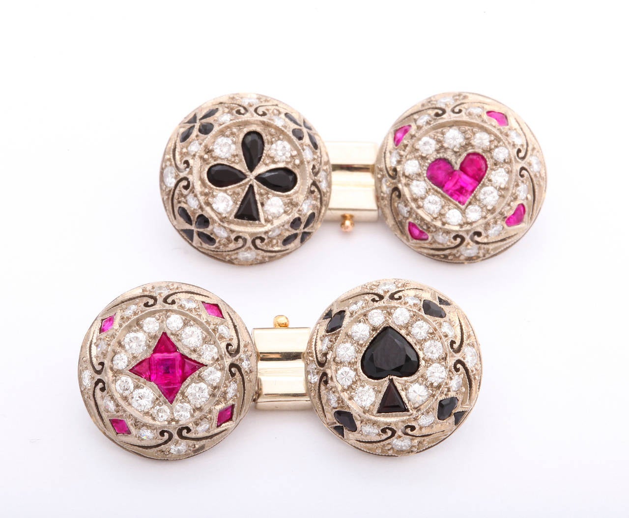 This playful late 20th century cufflink and four-stud dress set by renown jewelry designer Lucy Campbell of London, has the art deco look of the 1920s, featuring rubies and onyx set in 18K white gold surrounded in diamonds, making up the four card