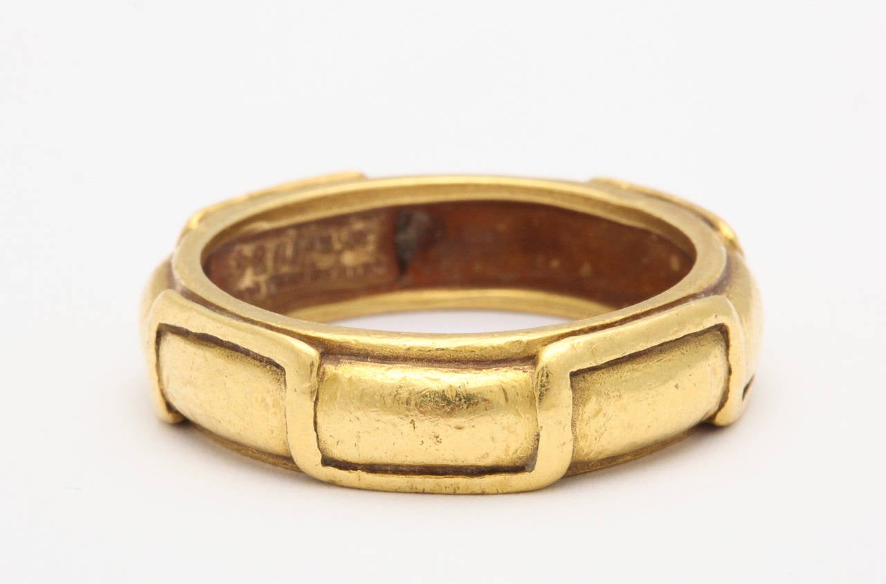 A handsome and distinctive Arts and Crafts inspired 18K gold man's ring by award winning jewelry designer Barry Kieselstein-Cord, dated 1984, fitting a size 11 finger.