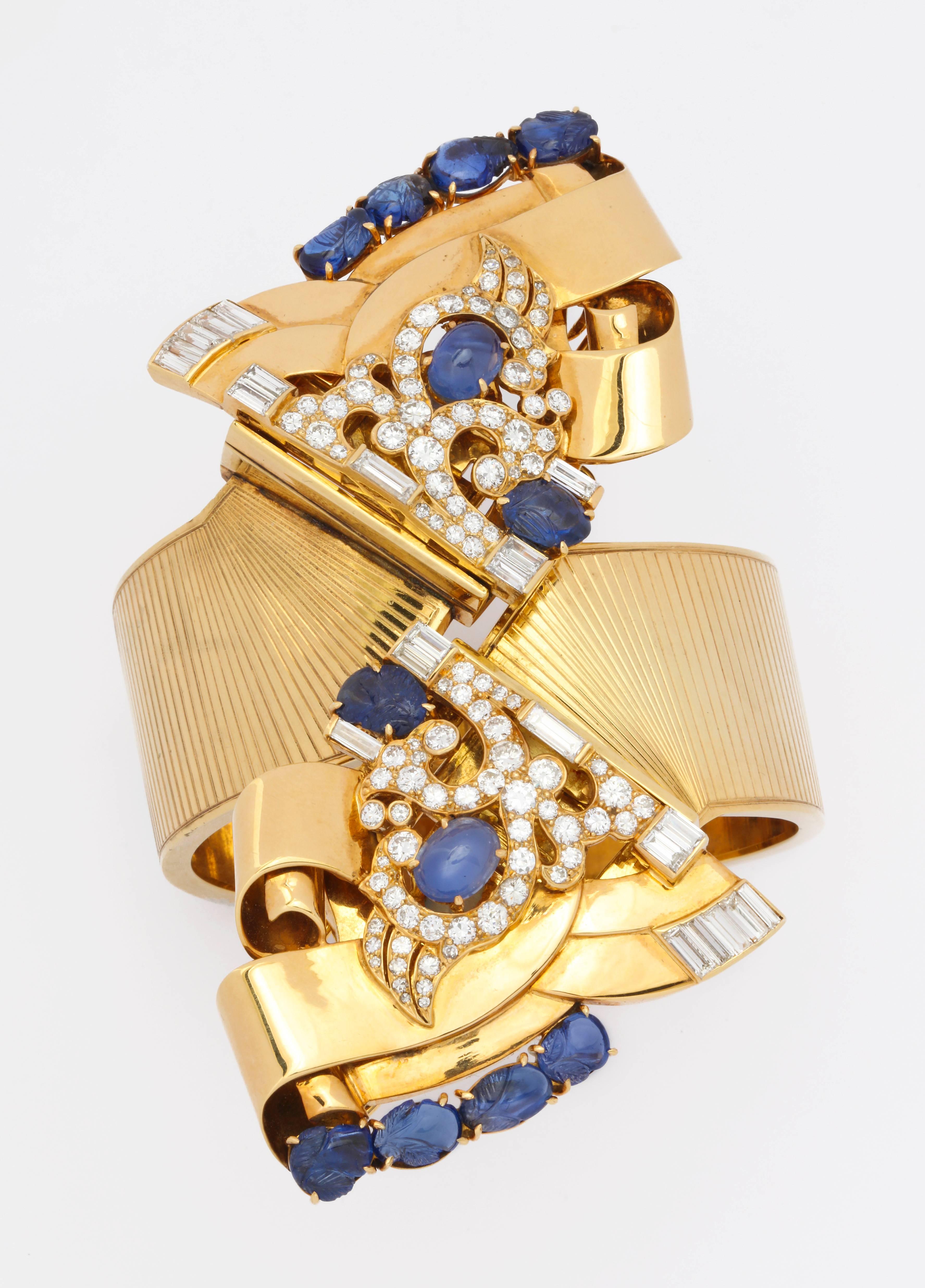 A stunning custom made 1930s Hollywood style, society bracelet in 14K gold by E.M. Battle, featuring removable dress clips set with 52 round diamonds of 1.65 cts, and 22 baguette diamonds of 2.20 cts,, as well as 12 cabochon and carved sapphires of