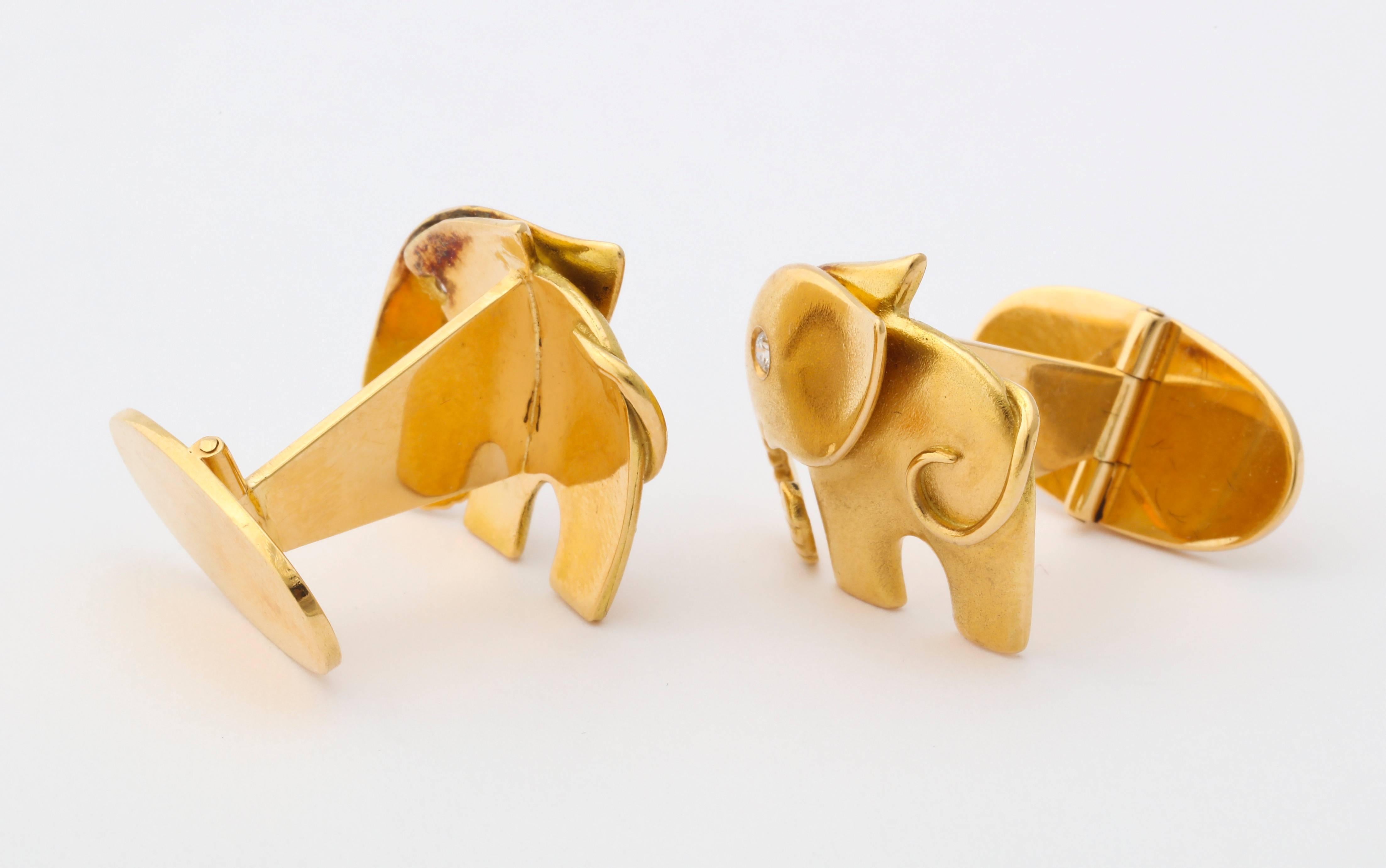 Charming and whimsical elephant cufflinks crafted in 18K gold, the eyes set with diamonds. Marked 750, with registry numbers and a signature mark of an 