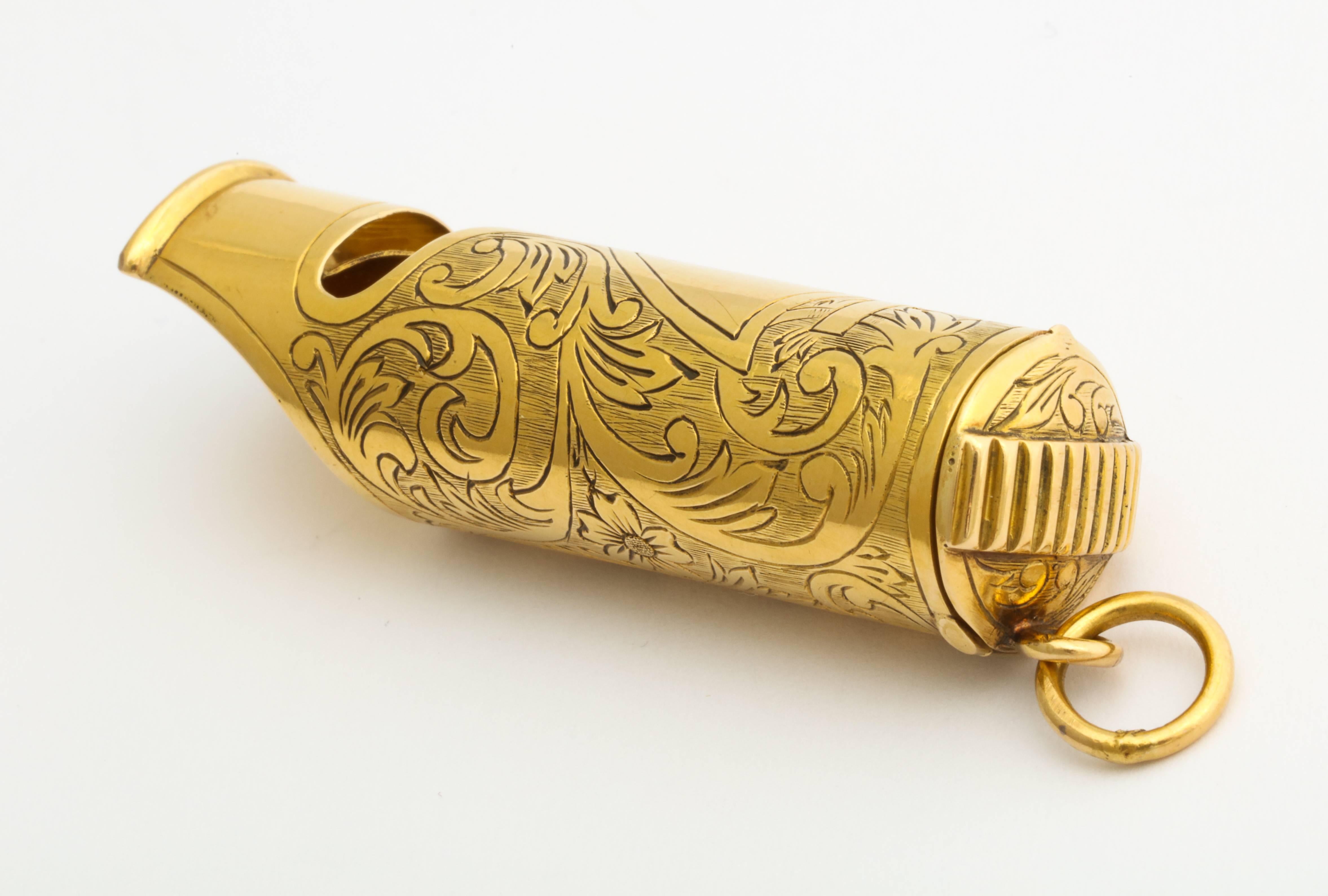An unusual and elegant turn of the century 18K gold carriage whistle, worn by a gentleman as a watch fob or a lady on her chatelaine, with hand engraved flourishes, the match striker cover hinges open to a compartment that originally held matches,