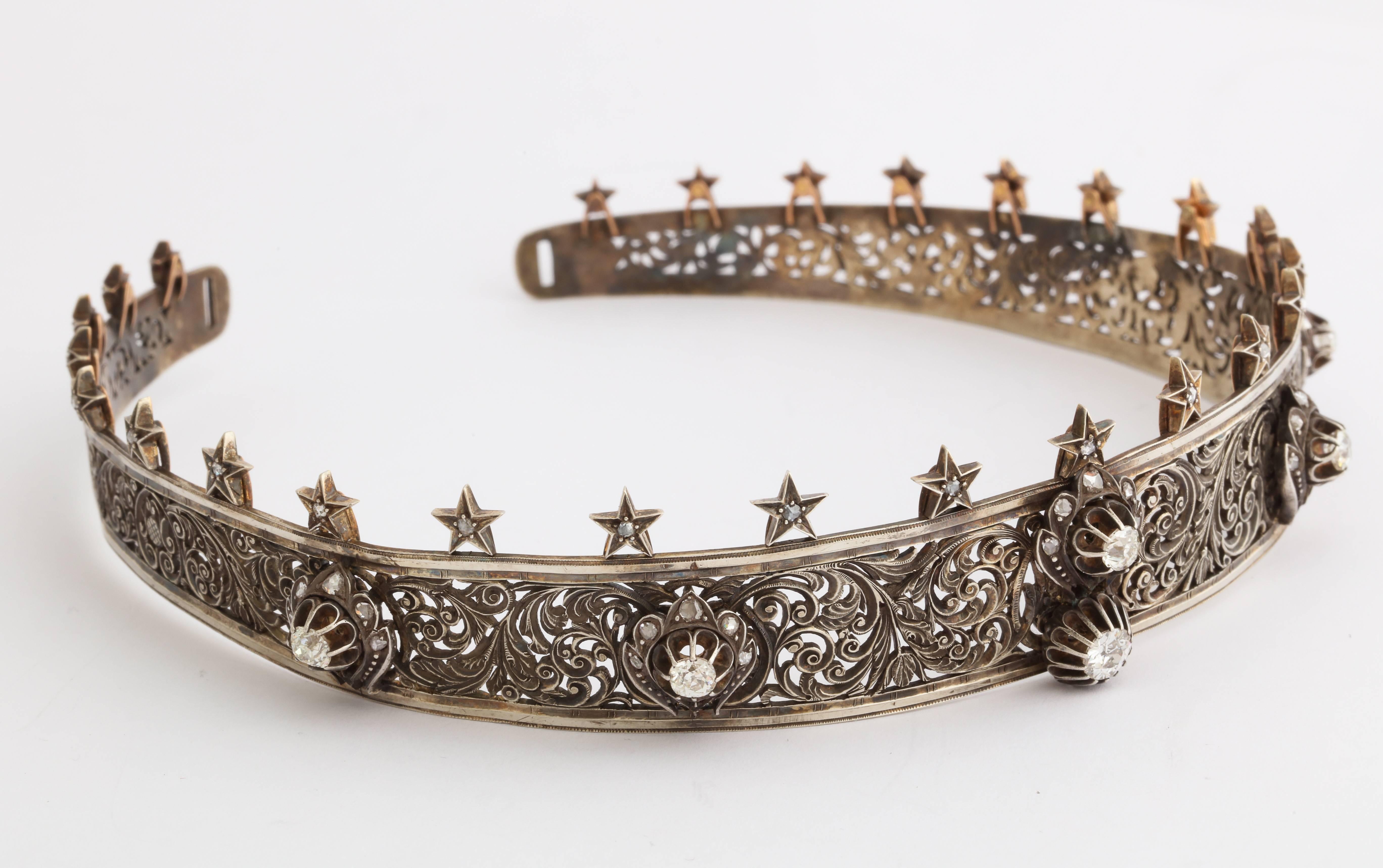 Sourced from a fine old estate in Palm Springs, CA, we are told by the owner, that this lovely piece had been worn in three royal weddings. A finely hand cut openwork metal tiara of intricate scrolling design in silver and gold, set with six