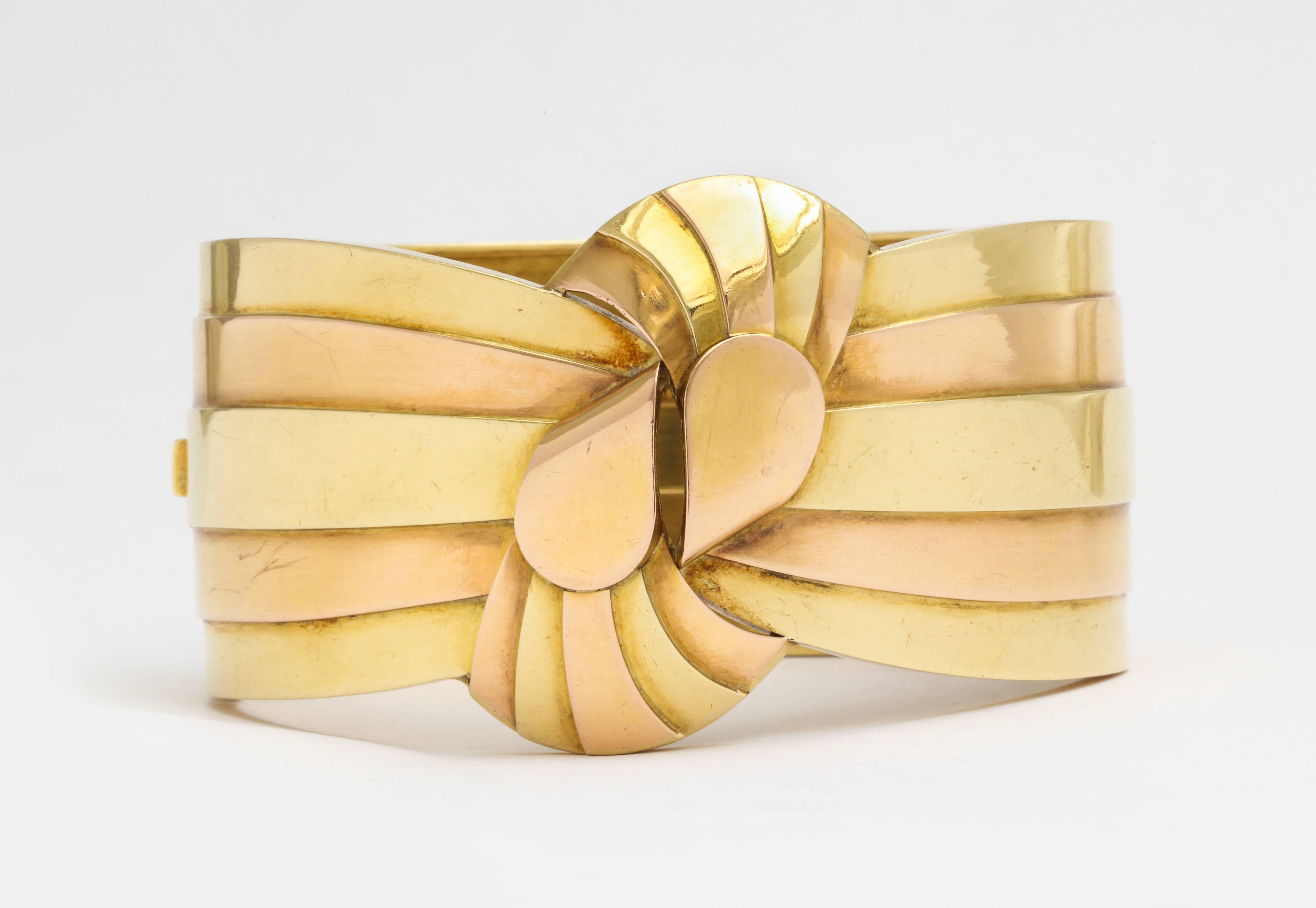 A stunning French Retro two tone 18K gold cuff bracelet as wide ribbons tied in a flat modern knot.  1 1/2 inches x 8 inches. French gold marks.