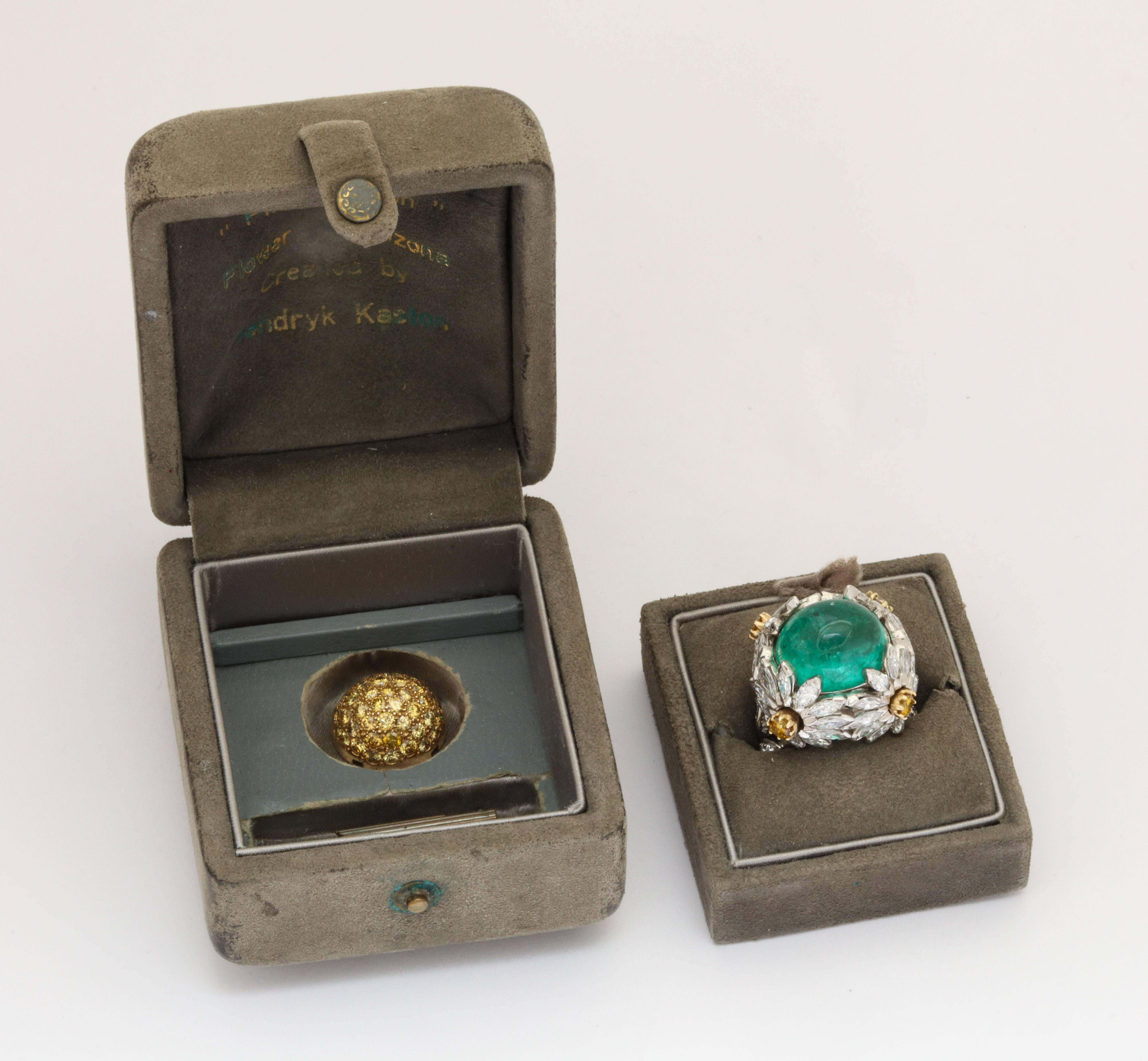 Two rings in one - a unique cocktail ring by renown musician/bow maker/jewelry artist Hendryk Kaston of platinum and 18K gold as four large desert flowers set with 4.20cts of round and marquise cut diamonds GH/VS framing a 23ct M12 cabochon emerald