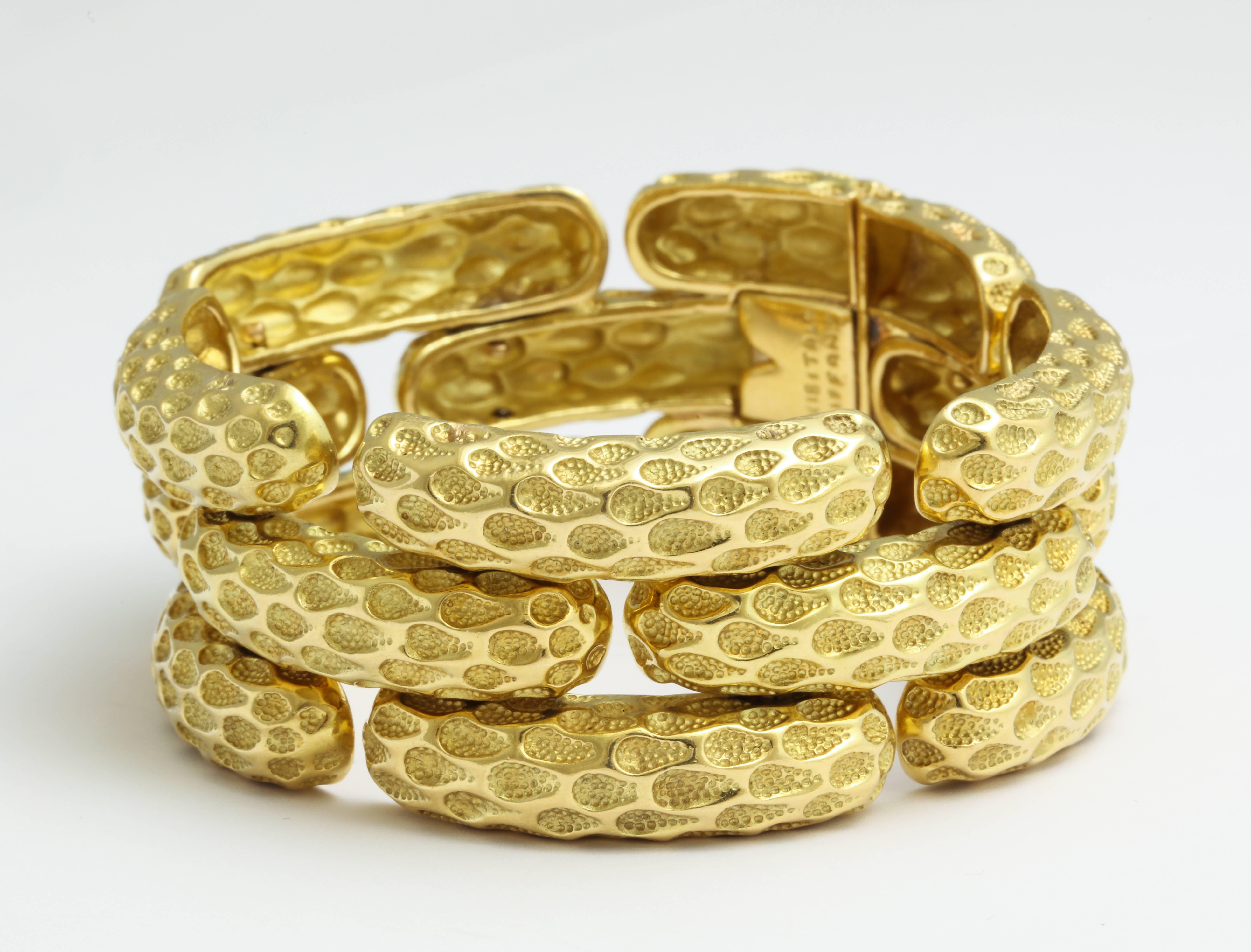 A smart and substantial 1970s Tiffany bracelet in 18K gold with a polished surface pattern replicating net, contrasted by hand applied texture deep in the recesses, all nicely articulated to be comfortably worn day into night. Marked Tiffany - Italy