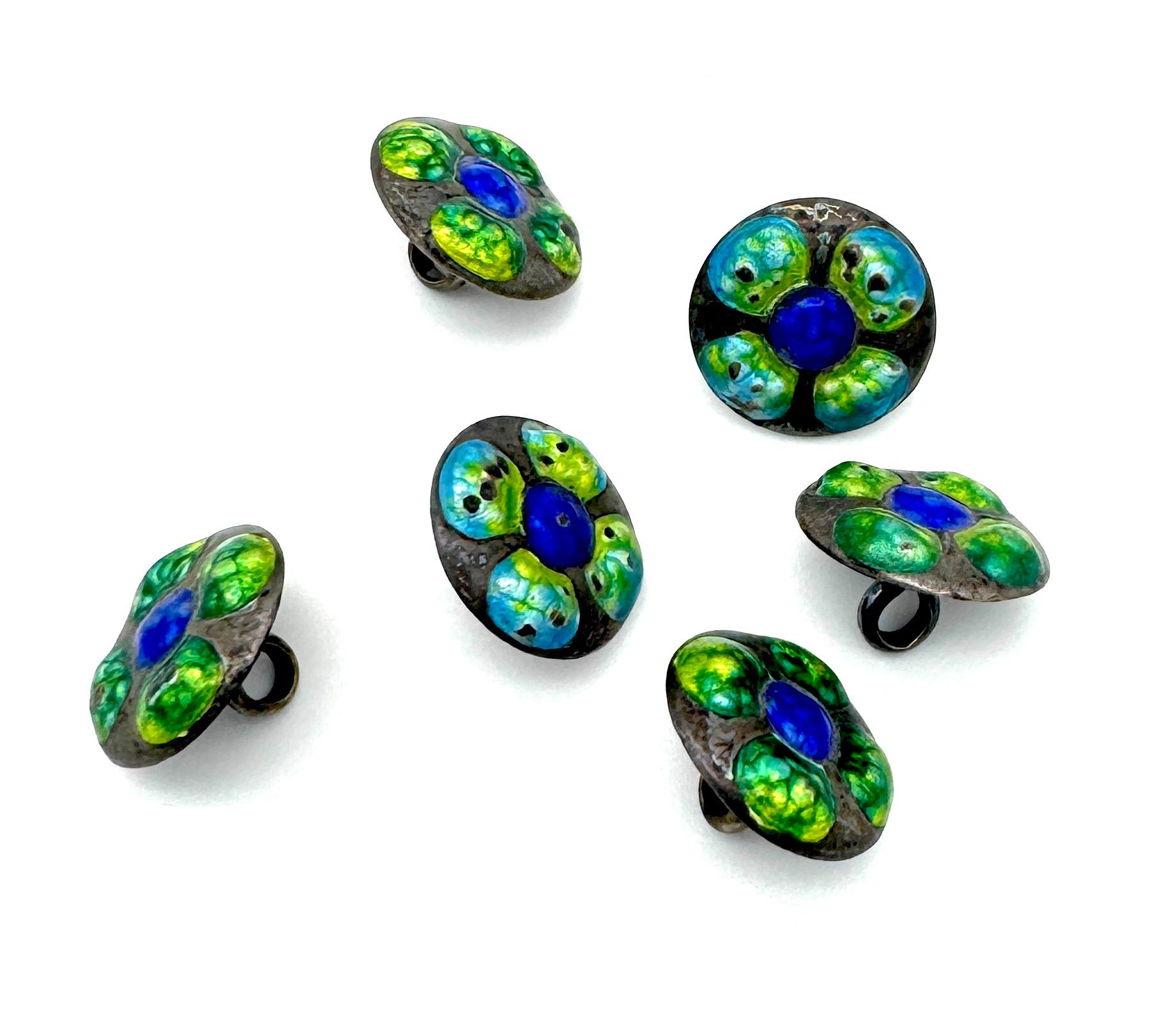 This set of six buttons was designed in the Arts& Crafts taste of the last decades of the 19th century. The buttons are made out of sterling silver and sare impressed with the British lion for sterling. The buttons are impressed with the letters J-F