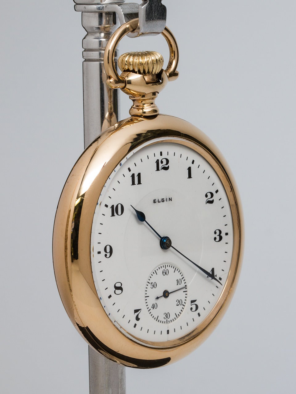 Elgin Yellow Gold Filled 16-S Open Face Railroad style pocket watch circa 1920's. Featuring white enamel dial, arabic indexes, and blued steel hands. Powered by 17 jewel manual wind movement with subsidiary seconds. Stem wind and stem set. Heavy