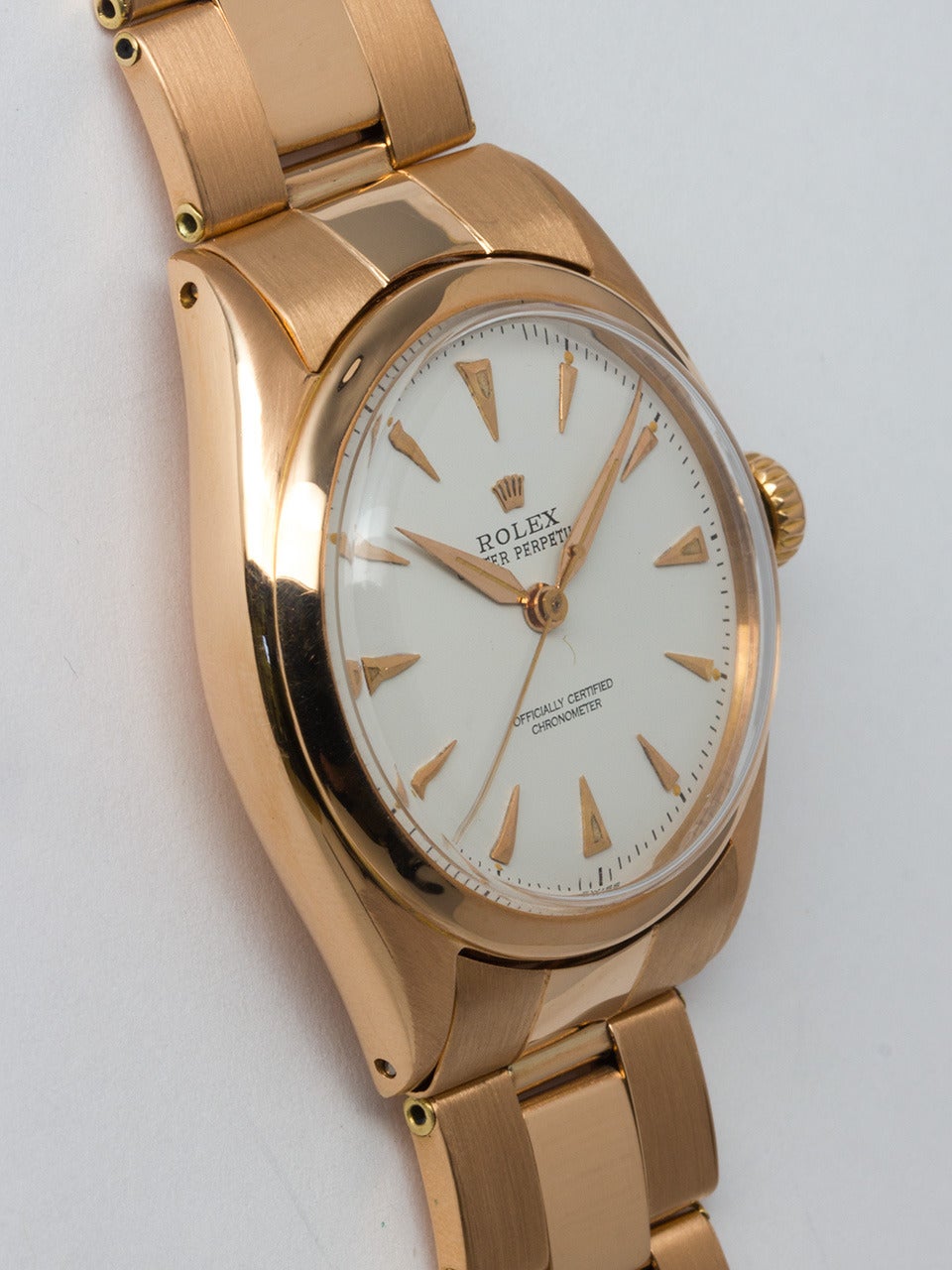 Rolex 18k rose gold Oyster Perpetual wristwatch, Ref. 6085, circa 1958. 34mm case with smooth bezel and acrylic crystal. Beautifully restored white dial with raised dagger indexes with luminous pink alpha hands. Self-winding calibre A260 movement