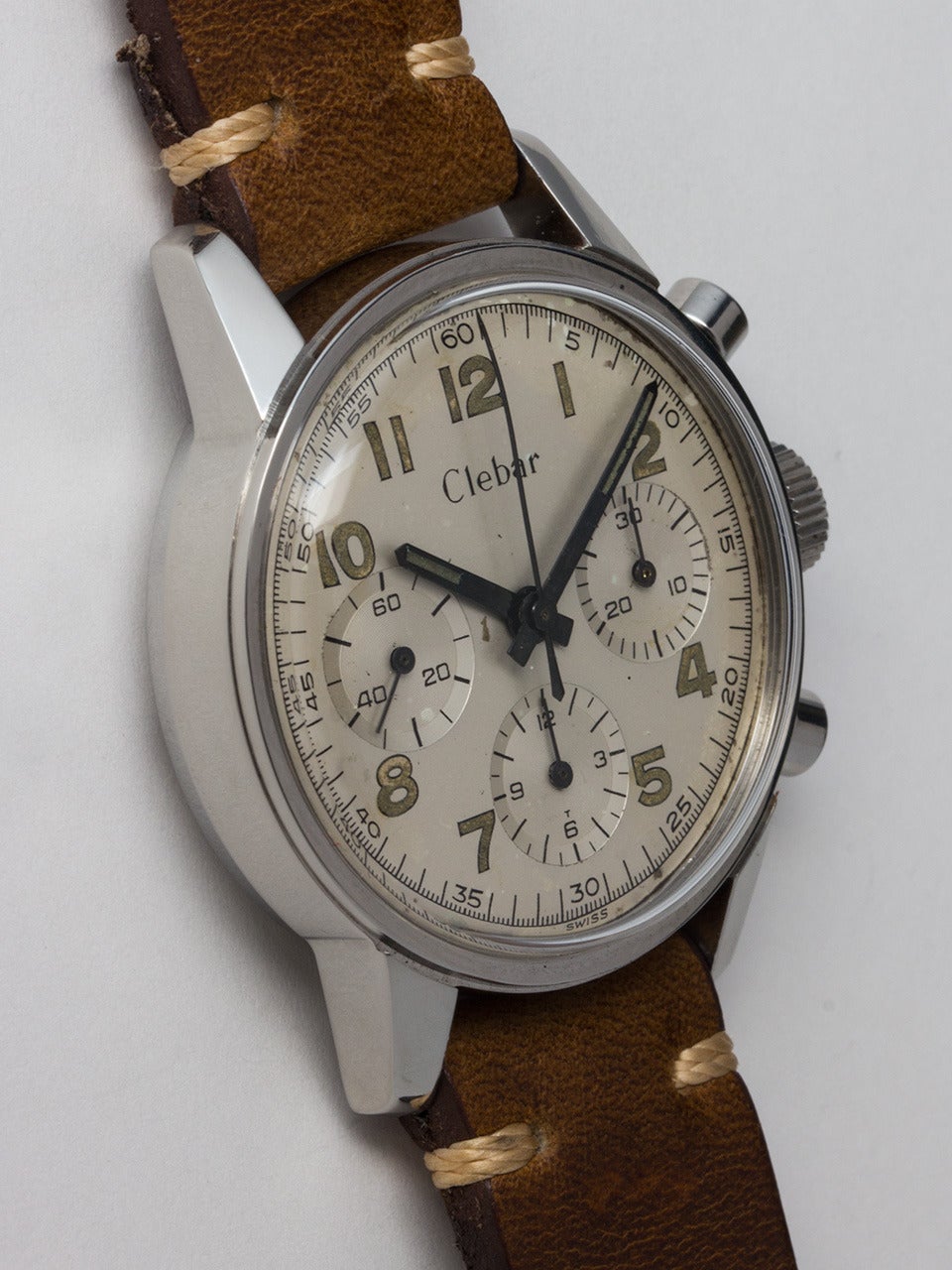 Clebar Stainless Steel Chrongraph wristwatch, circa 1950s. Great looking model featuring a 36 X 44mm screw back case with heavy lugs, wide bezel and round pushers. With a beautiful original two-tone matte silvered dial with luminous Arabic indexes