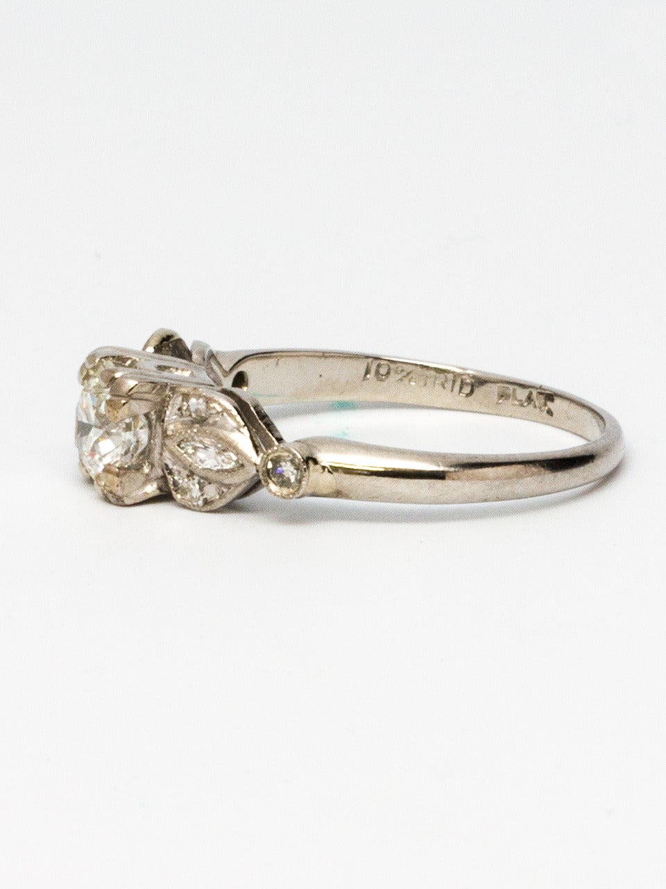 Vintage 1940s platinum engagement ring with transitional cut round brilliant 0.51ct F-VS2.  One marquise and three round melee diamonds flanking each side. Very pretty retro design. Size 5.25 with ability to adjust.

SKU: 44534