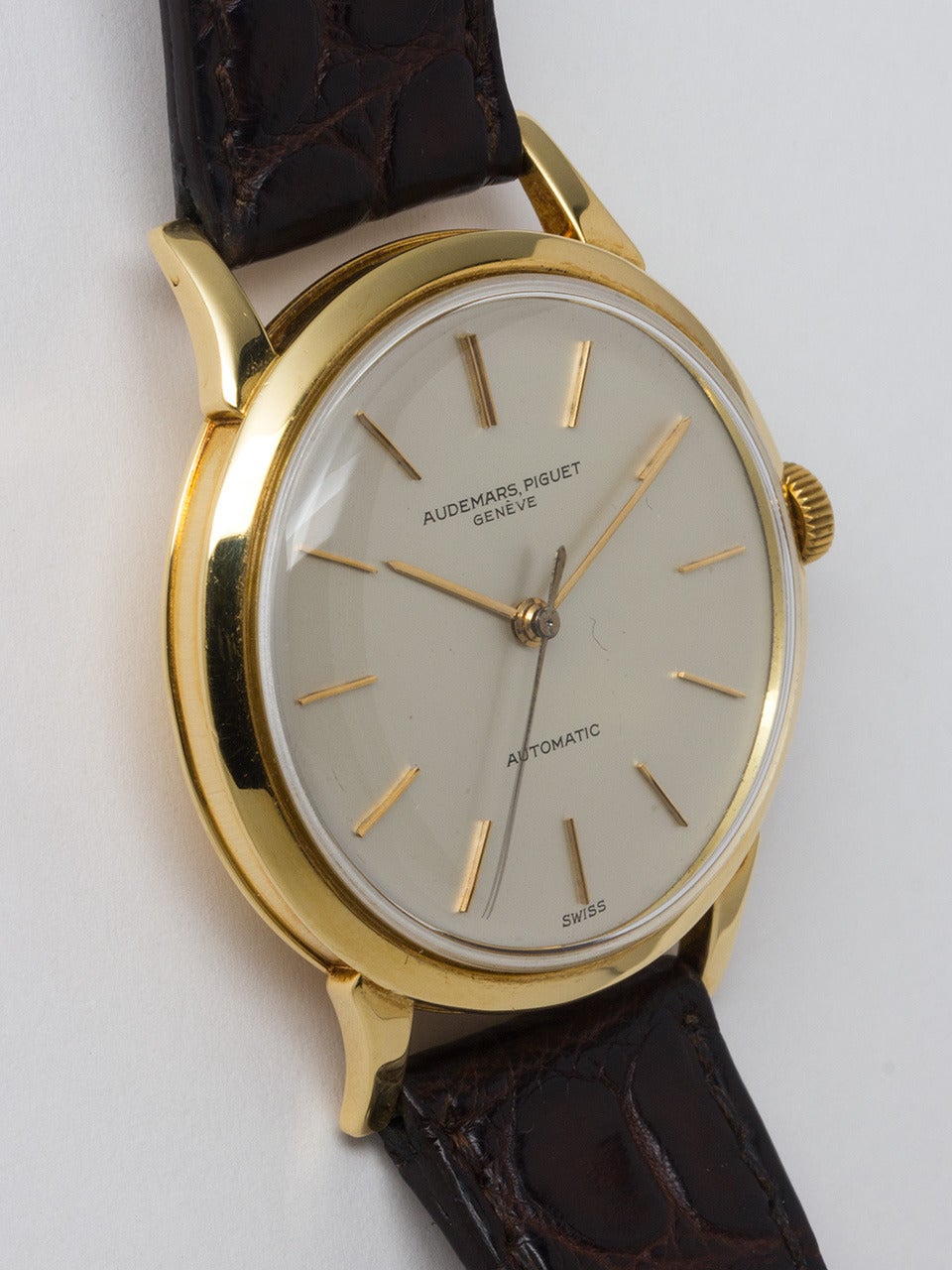 Audemars Piguet 18K Yellow Gold Automatic Dress Model Wristwatch circa 1960s. Oversized 36 X 44mm case with concave stylized sides and extended lobed lugs. Beautiful original silvered satin dial with gold applied indexes and hands. Powered by