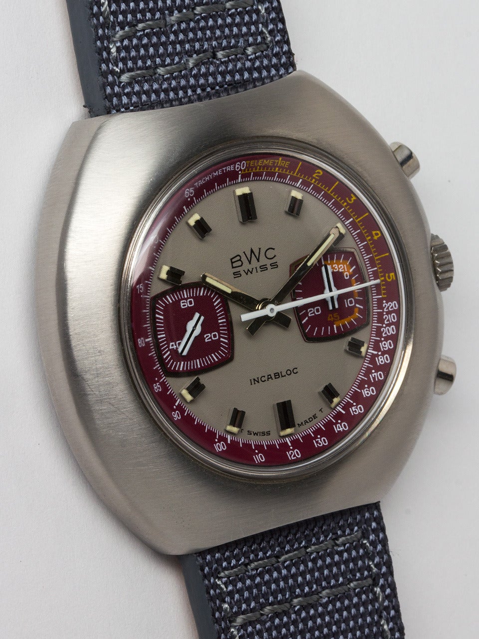 BWC Swiss Chronograph Wristwatch circa 1970s. Massive oversize tonneau shaped chronograph. Very striking gray and burgundy detail dial with prominent silver indexes and large match stick hands, Incabloc printed on dial. 17 jewel manual wind 2