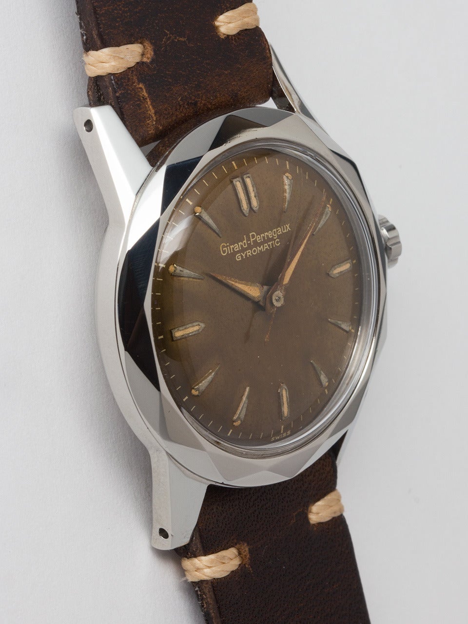Girard Perregaux Stainless Steel Gyromatic Wristwatch circa 1950s. Medium sized 32 X 38mm screw back case with complex faceted bezel and signed GP crown. Distinctive chocolate color change dial with raised teardrop indexes and tapered luminous