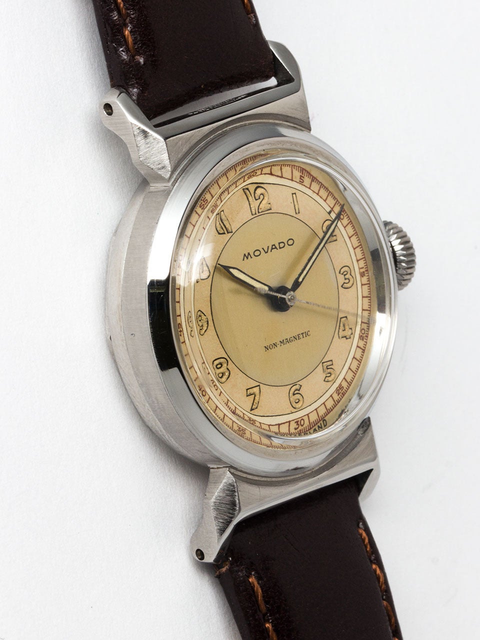 Movado Stainless Steel Wristwatch circa 1940s. Round case with hooded lugs and screw down case back. With original gorgeous 2 tone dial with luminous indexes, red seconds track, and luminous pencil hands. 17 jewel manual wind movement with sweep