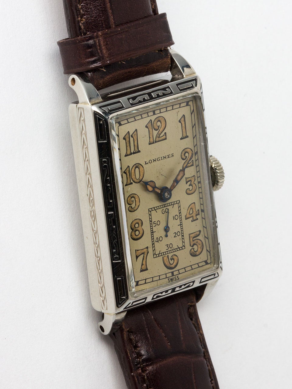 Longines WGF narrow rectangular 22 X 38mm engraved bezel case circa 1920's. Exceptional condition and very pleasing case, original matte silvered dial with radium indexes and matching hands. Powered by 17 jewel high grade Longines calibre manual