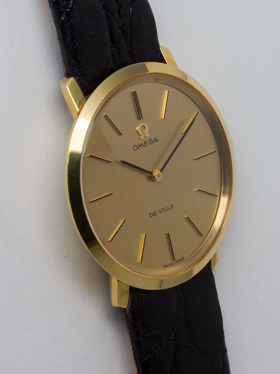 Omega Yellow Gold Filled De Ville Wristwatch ref 111.077 circa 1970. 33 x 35 gold filled top and stainless steel back thin dress model. Very pleasing classic dress model with original champagne dial with thin gold sticks and black painted thin baton