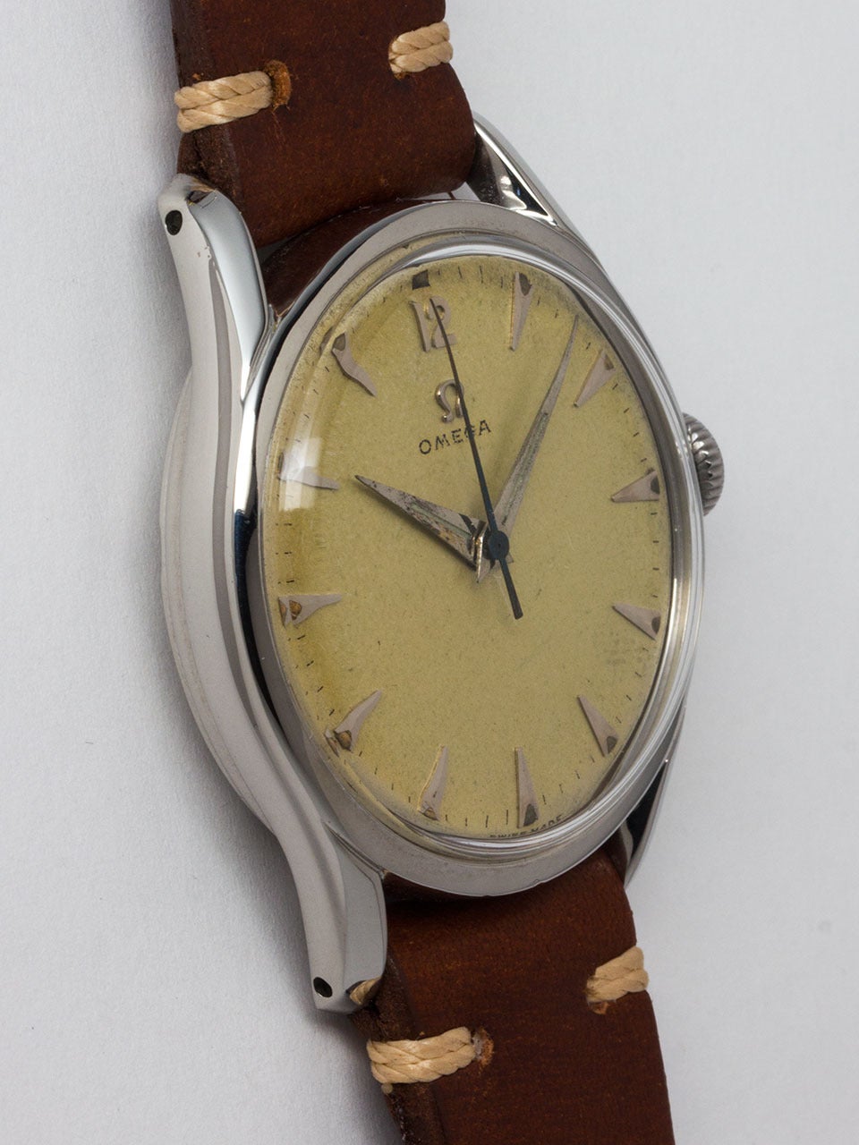 Omega Stainless Steel Bombe Wristwatch circa 1950s. Oversize dress model measuring 36 x 43mm. With original lightly patina'd dial with raised silver indexes, applied silver Omega logo, and with tapered sword hands. 17 jewel manual wind movement with
