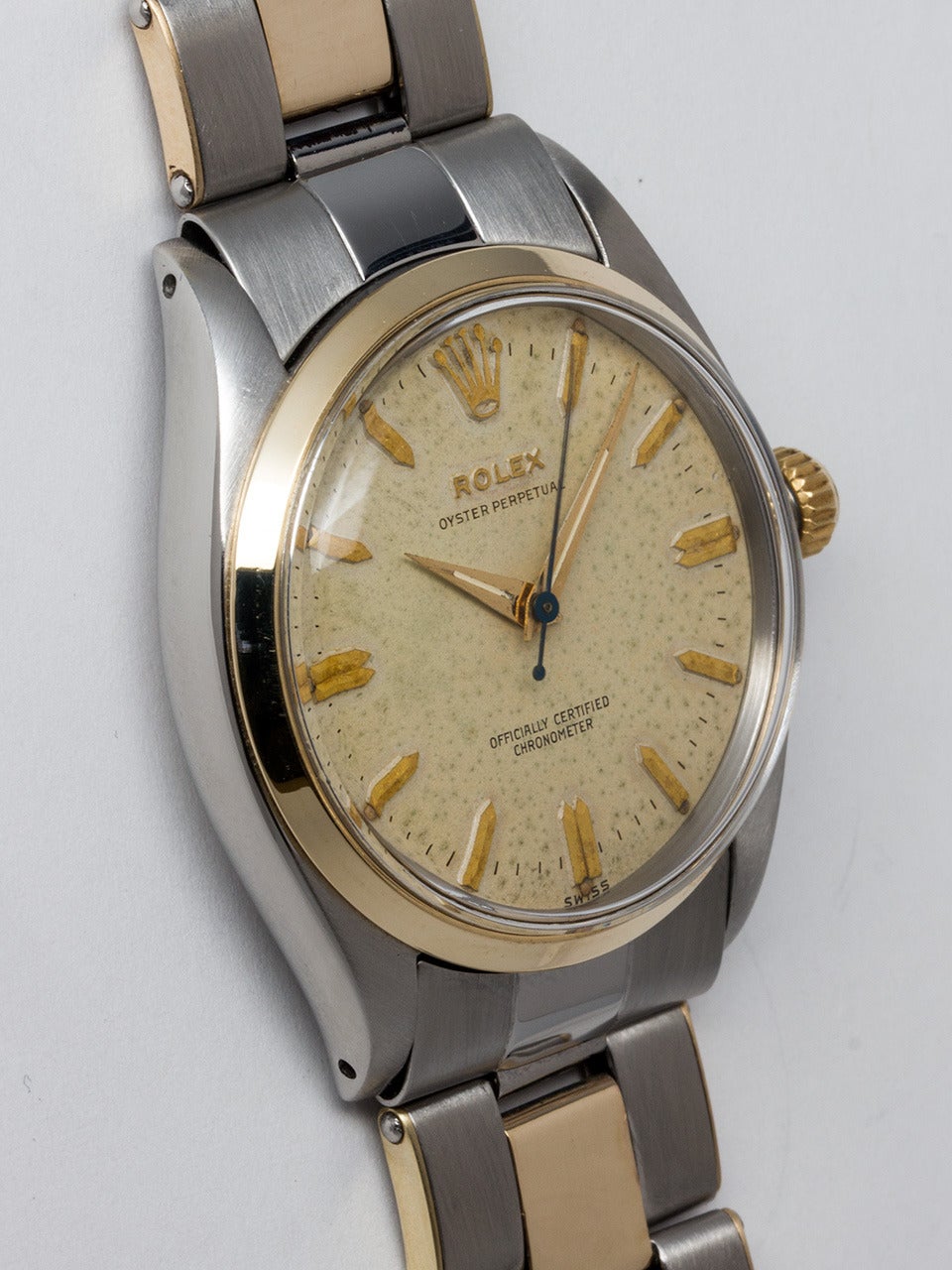 Rolex Stainless Steel and 14K Yellow Gold Oyster Perpetual Wristwatch ref 6564 serial # 359,xxx circa 1958. 34mm diameter case with smooth bezel and acrylic crystal. Original patina'd silvered dial with gold indexes and tapered gilt sword hands.