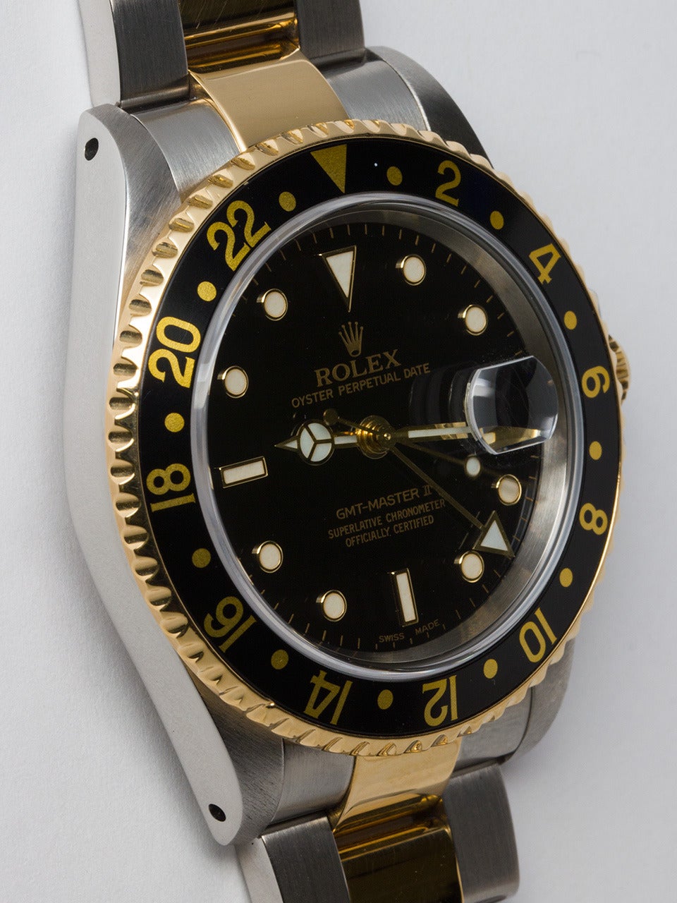 Rolex stainless steel and 18K yellow gold GMT-Master II, ref 16713, serial # P7 circa 2000. 40mm diameter case with sapphire crystal, black and gold 24 hour bezel, glossy black dial with Super-LumiNova indexes and hands. Powered by self wind
