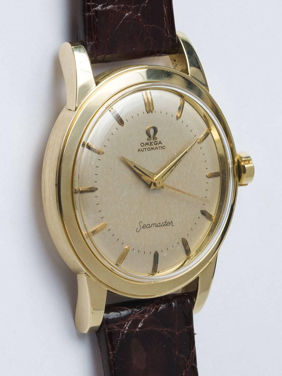 Omega 14K Yellow Gold Automatic circa 1950s. 35 x 43mm diameter case with wide bezel and screw down case back. Original silvered satin dial with raised patina'd gold indexes and gilt dauphine hands. Powered by calibre 354 bump automatic movement