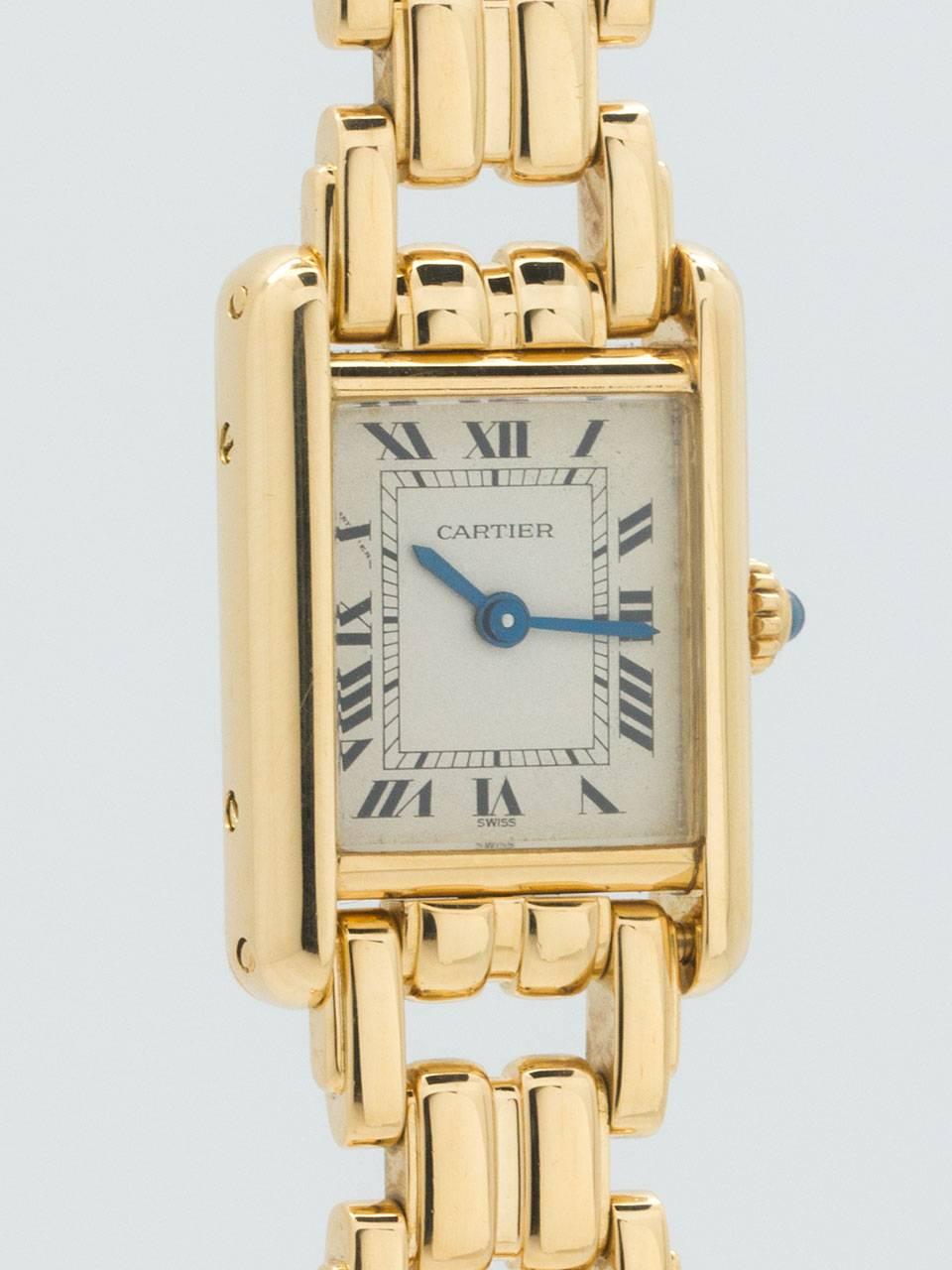 Lady Cartier Tank Louis Mini 18K YG with Bracelet circa 1990s. Mini size lady Tank Louis with acrylic crystal and cabochon sapphire crown. Soft white dial with printed black Roman numerals and blue steeled hands. Powered by quartz movement. With