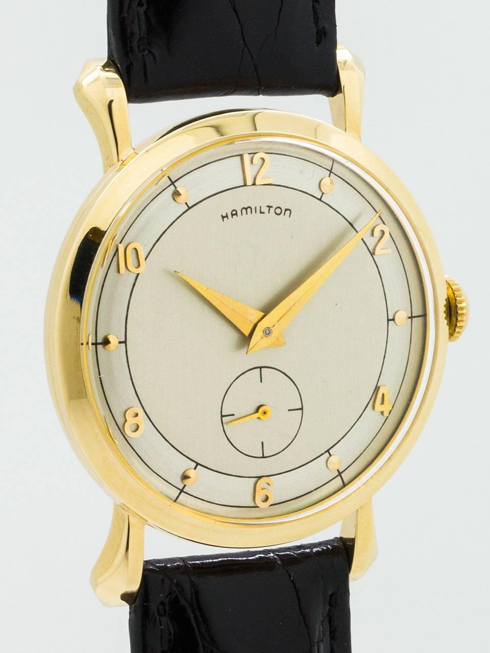 Hamilton 10K Yellow Gold “Parker B” model circa 1958. Featuring 30mm diameter case with tear drop lugs and acrylic crystal. Beautiful condition 2 tone silvered satin dial with applied 18K yellow gold hour indexes and tapered alpha style hands.